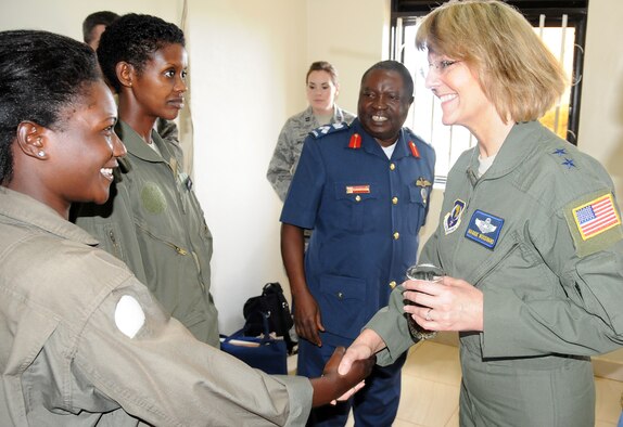 ENTEBE AIR BASE, Uganda -- Air Forces Africa Commander Maj. Gen. Margaret
Woodward (left) meets Ugandan Peoples Defence Air Force pilots Pilot Cadet
Carolyne Nanyema (right) and Lieutenant Naomi Karungi (right center) while
UPDAF Deputy Commander Brig. Gen. Samuel Turyagyenda (center) looks on.
General Woodward was touring the air base during a Senior Leader Engagement
to the partner nation focused on sharing expertise and capacity building.
(U.S. Air Force photo by Master Sgt. Jim Fisher)
