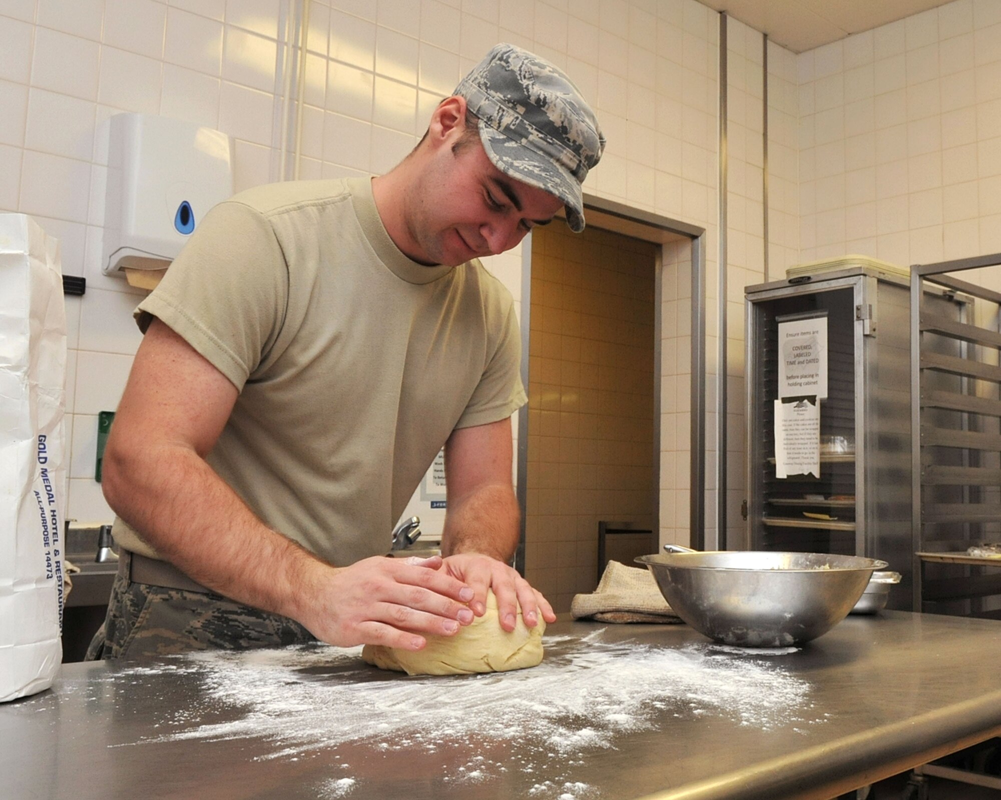 RAF MILDENHALL, England - Airman 1st Class Corey Adams, 100th Force Support Squadron, kneads pastry dough at the Gateway Dining Facility here Jan. 4, 2012. The dining facility took first place in the 2011 USAFE Food Service Excellence Award, Single-Facility category. They were judged on several areas, including customer satisfaction, training and motivational programs and participation in the nutrition and Grab-n-Go program. (U.S. Air Force photo/Senior Airman Jerilyn Quintanilla)