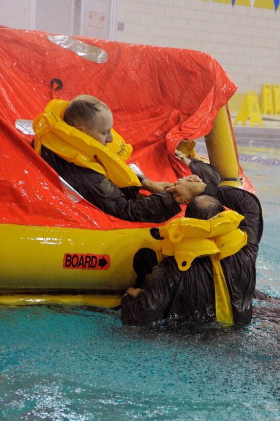 Students participating in a Survive, Evade, Resist, Escape refresher course climb into a 12-man life raft during simulated rough water exercise Nov. 17 at the Prince George's Sports & Learning Complex in Landover, Md. Air crews must attend a S.E.R.E. refresher course every three years to keep up to date on their training and learn new S.E.R.E. tactics. (U.S. Air Force Photo/Senior Airman Perry Aston)


