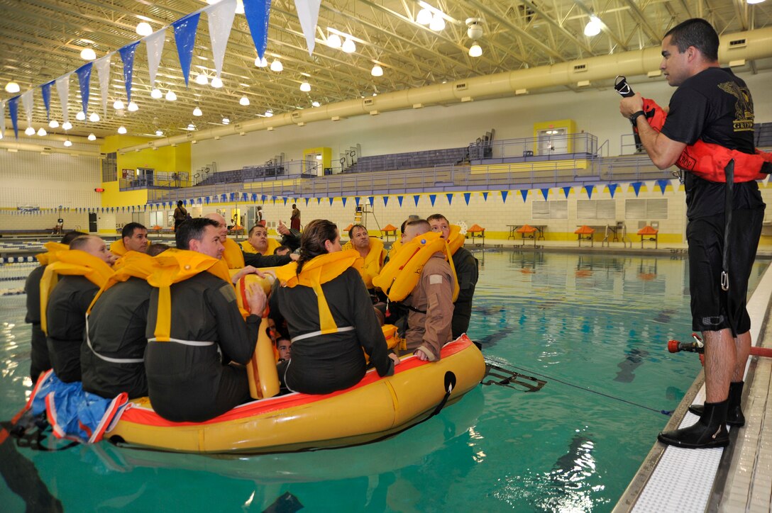 Staff Sgt. Christopher DeJesus, 89th Operations Support Squadron Survival, Evasion, Resistance, Escape specialist, shows S.E.R.E. refresher course students how to properly use a rescue strop Nov. 17 at the Prince George's Sports & Learning Complex in Landover, Md. (U.S. Air Force Photo/Senior Airman Perry Aston)

