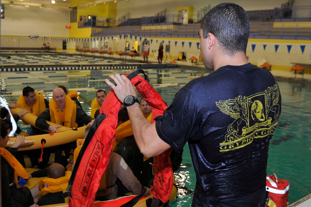 Staff Sgt. Christopher DeJesus, 89th Operations Support Squadron Survival, Evasion, Resistance, Escape specialist, shows S.E.R.E. refresher course students how to properly use a rescue strop Nov. 17 at the Prince George's Sports & Learning Complex in Landover, Md. (U.S. Air Force Photo/Senior Airman Perry Aston)


