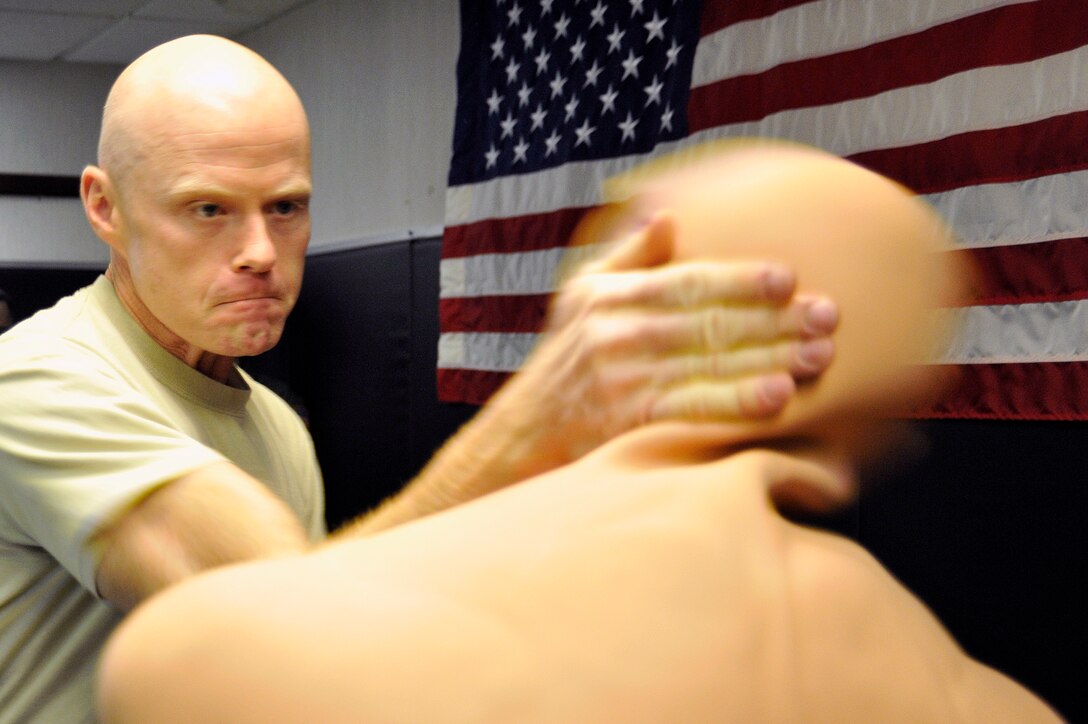 Maj. Sean Macdermott, 779th Medical Operations Squadron physician, practices an ear slap technique on a grappling dummy during combative training at the Joint Base Andrews S.E.R.E facility Nov. 15. Combative training provides Airmen with self defense knowledge in case they ever have to physically protect themselves from harm. (U.S. Air Force Photo/Senior Airman Perry Aston)


