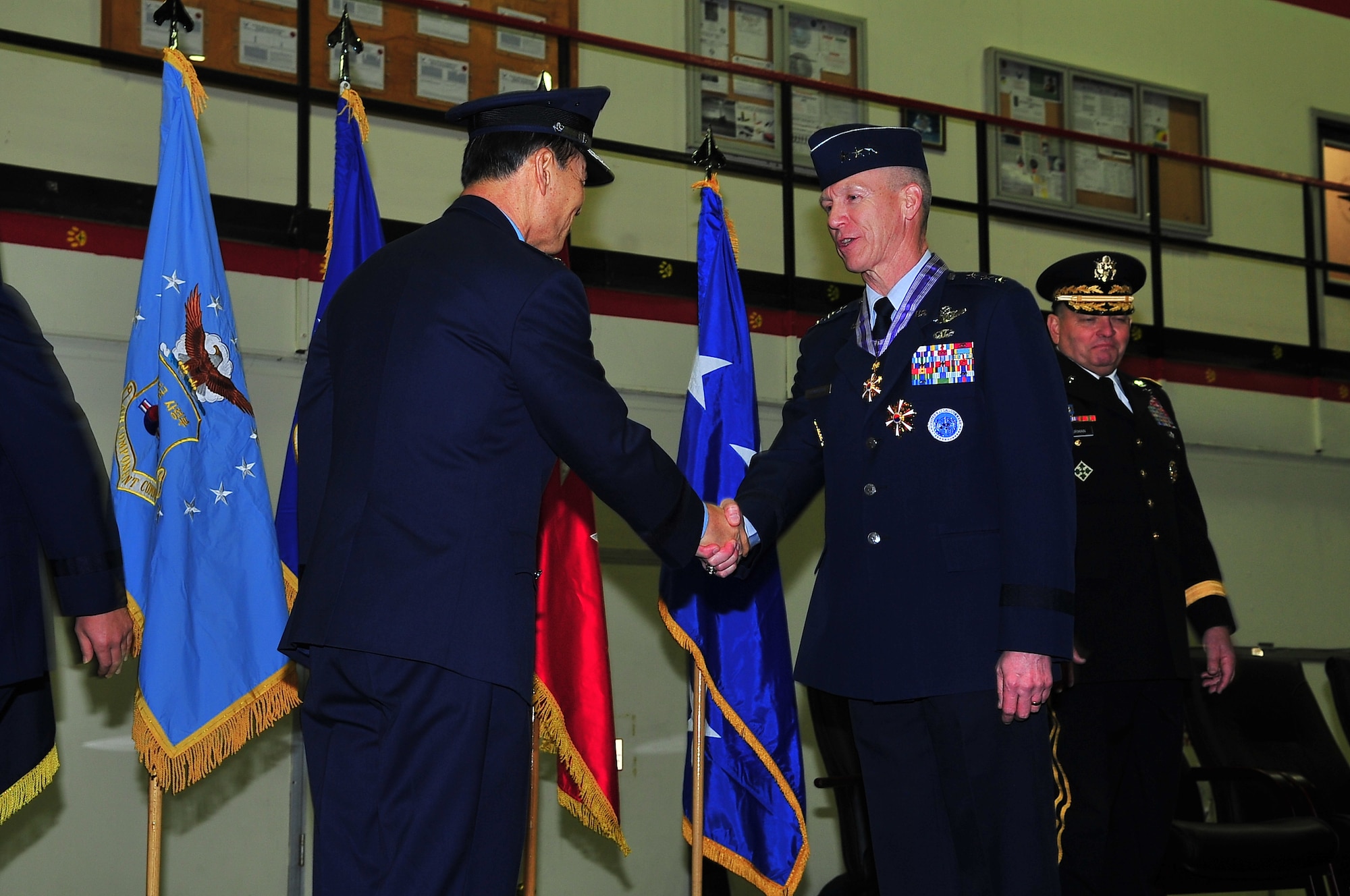 Gen. Jong Heon Park, Republic of Korea chief of staff, presented Lt. Gen. Jeffrey Remington with The Order of the National Security Merit Gukseon Medal on behalf of South Korean President Myung-Bak Lee, during a change of command ceremony at Osan Air Base, Republic of Korea, Jan. 6, 2012. (U.S. Air Force photo/ Staff Sgt. Daylena Gonzalez)