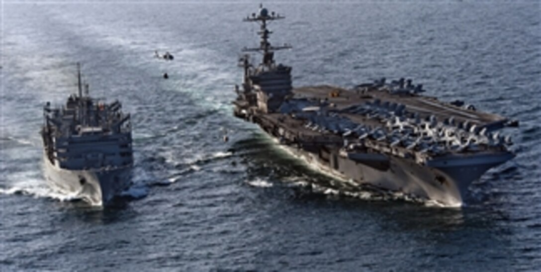 The aircraft carrier USS John C. Stennis (CVN 74) is underway alongside the Military Sealift Command fast combat support ship USNS Rainier (T-AOE 7) during a vertical replenishment in the Arabian Sea on Jan. 5, 2012.  The John C. Stennis is deployed to the U.S. 5th Fleet area of responsibility conducting maritime security operations and support missions as part of Operation Enduring Freedom.  