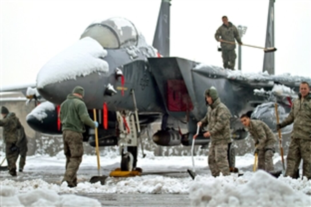 U.S. Air Force airmen remove snow from an F-15E Strike Eagle on Bagram Air Field, Afghanistan, Jan 5, 2012. The airmen are assigned to the 455th Expeditionary Aircraft Maintenance Squadron.