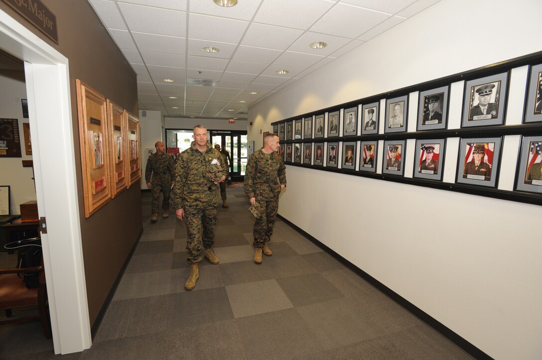 Colonel Daniel P. Ermer, commanding officer MCLB Barstow,::r::::n::accompanies new commanding general Brig. General Vincent::r::::n::A. Coglianese through the hallway of Headquarters Building 15,::r::::n::Jan. 6. They reflect on the prior commanding officers of::r::::n::Marine Corps Logistics Base Barstow.