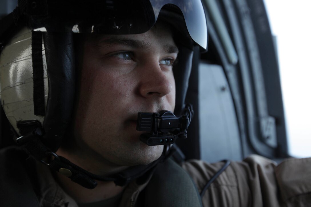 Crew chief Sgt. Kurt Udseth, 24, and Westminster, Md. native flies with Marine Medium Helicopter Squadron 268 (Reinforced), 11th Marine Expeditionary Unit, here Jan. 6. The 11th MEU is currently deployed as part of the Makin Island Amphibious Ready Group (MKIARG) as the U.S. Central Command theater reserve force, also providing support for maritime security operations and theater security cooperation efforts in the U.S. 5th Fleet area of responsibility.