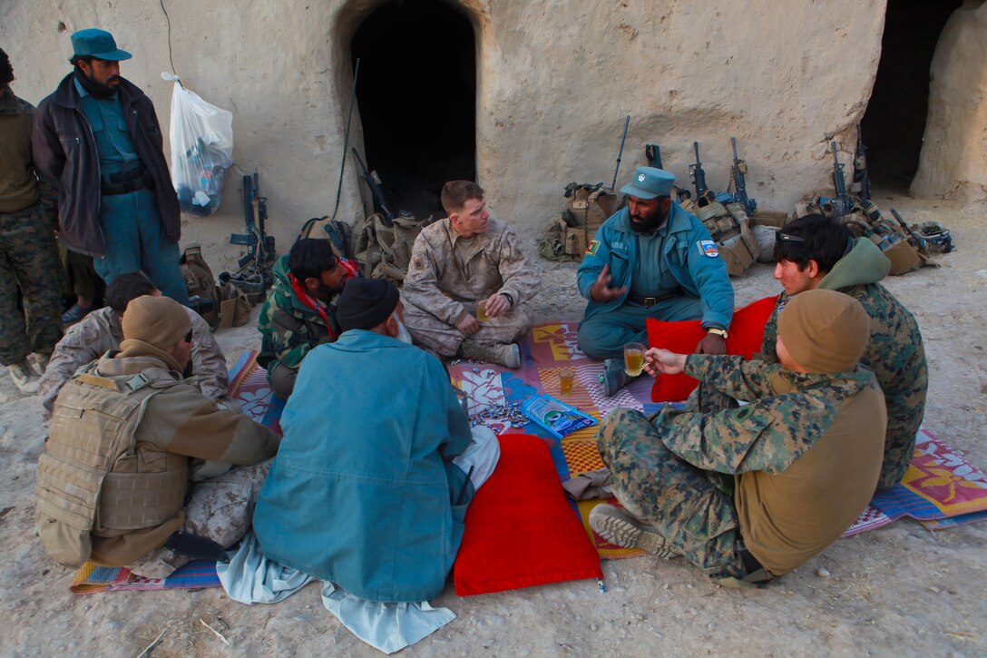 Marines and Afghans sit down to discuss future security measures and the placement of Afghan Uniformed Police security posts over a cup of chai tea.  Marines with Echo Company, 2nd Battalion, 4th Marine Regiment, along with their Afghan National Security Forces counterparts, participated in Operation Double Check, in which they cleared a number of compounds and other areas, built security posts, and established a security presence on the western side of the southern Musa Qal’eh riverbed.