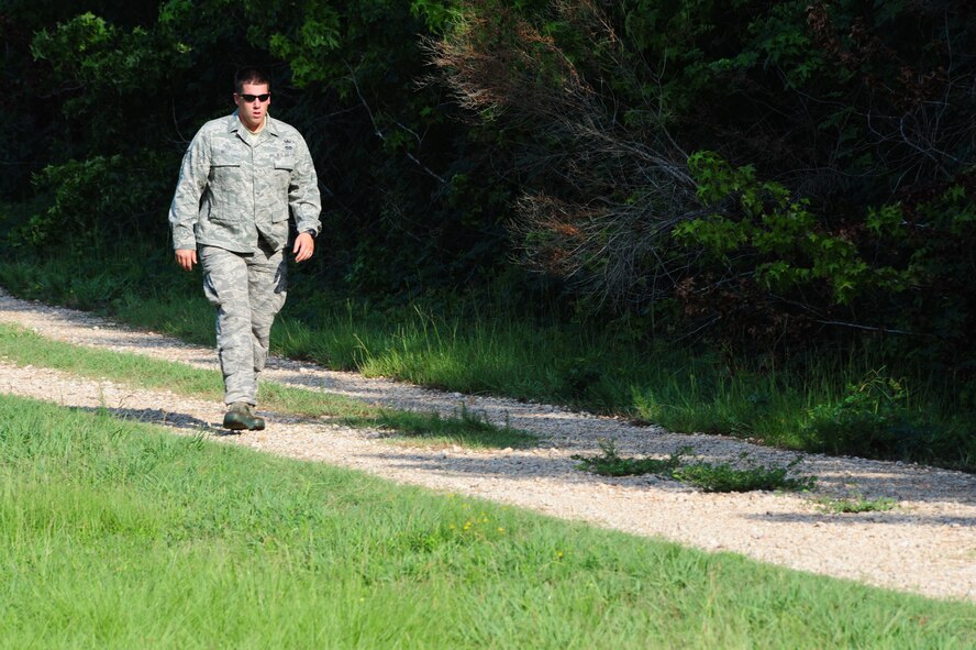 Senior Airman Bryan Bell returns from the Explosive Ordnance Disposal range on Barksdale Air Force Base, La., July 5, 2011. Personnel from EOD performed a bomb demonstration for 2nd Bomb Wing leadership for informative purposes and also served as an opportunity for EOD Airmen to get their monthly range qualification. (U.S. Air Force photo/Senior Airman Joanna M. Kresge) 