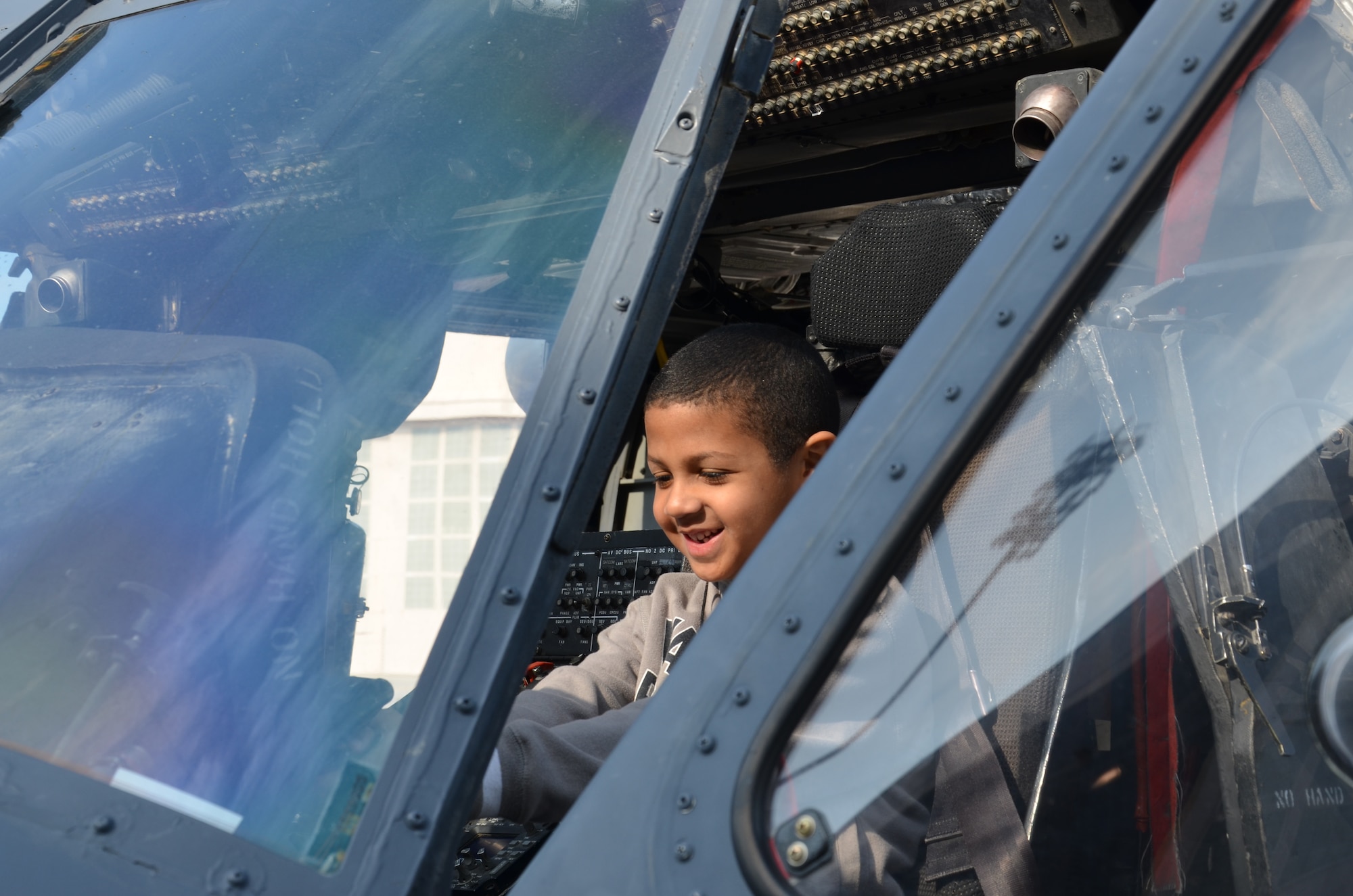 A child sits in the cockpit of a 920th Rescue Wing HH-60 Pave Hawk helicopter at Patrick Air Force Base, Fla., Jan. 7, 2012. Approximately 90 children of active duty and Reserve Airmen stationed at Patrick toured the aircraft as part of the Kids Understanding Deployments--also known as KUDOS--event on base. (U.S. Air Force photo/Staff Sgt. Anna-Marie Wyant)