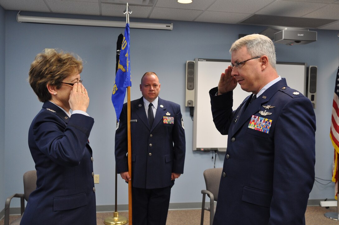 New 910th Communication Squadron Commander Lt. Col. Pete Milkovich renders salute to Col. Teresa Hams during an assumption of command held here today. The 910th Communication Flight officially achieved squadron status with Milkovich taking the reins as the first commander.