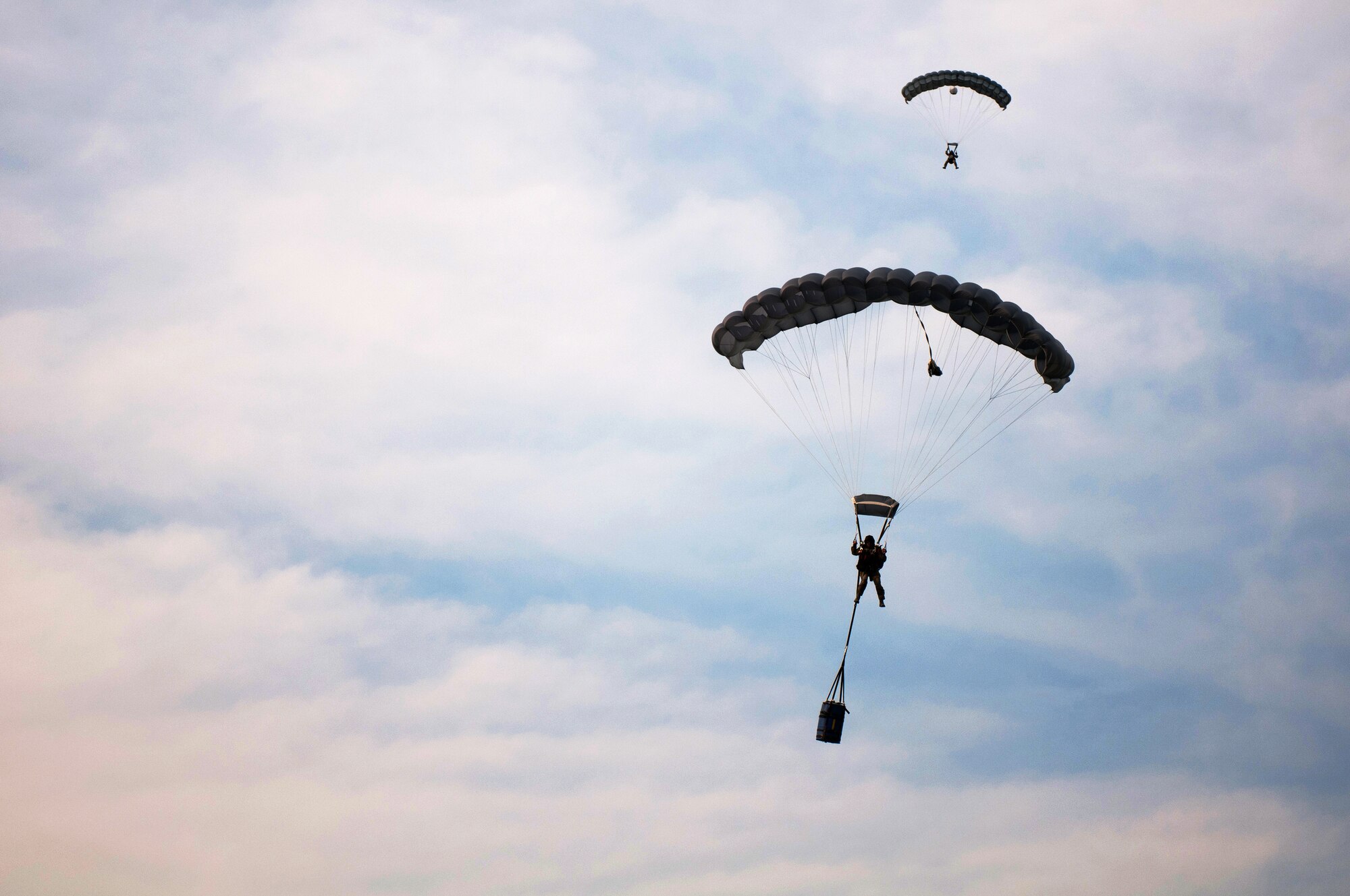 Two pararescuemen guide themselves to the drop zone at Camp Atterbury, Ind., June 14, 2011, during the second phase of a Precision Jumpmaster Course. The course was designed to provide instruction in the skills needed to rescue anyone on land or water, and condensed into three weeks the same amount of training that often takes years to complete. (U.S. Air Force photo by Master Sgt. Phil Speck)