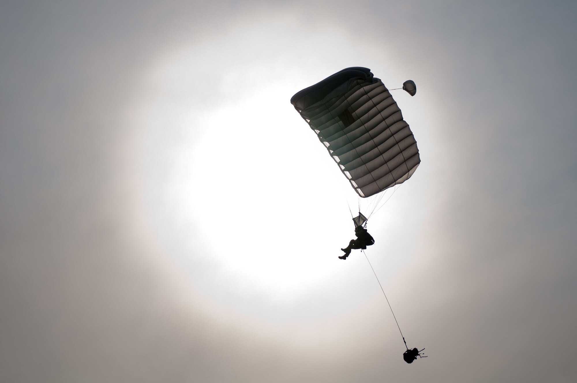 A pararescueman parachutes in to the drop zone at Camp Atterbury, Ind., June 14, 2011, during a Precision Jumpmaster Course taught by members of the Kentucky Air National Guard's 123rd Special Tactics Squadron. The three-week course also included ground training at the Kentucky Air Guard Base in Louisville, Ky., and water jump training in Selfridge, Mich. The course was unique in that active-duty forces were trained by members of the Air National Guard, organizers and participants said. (U.S. Air Force photo by Master Sgt. Phil Speck)
