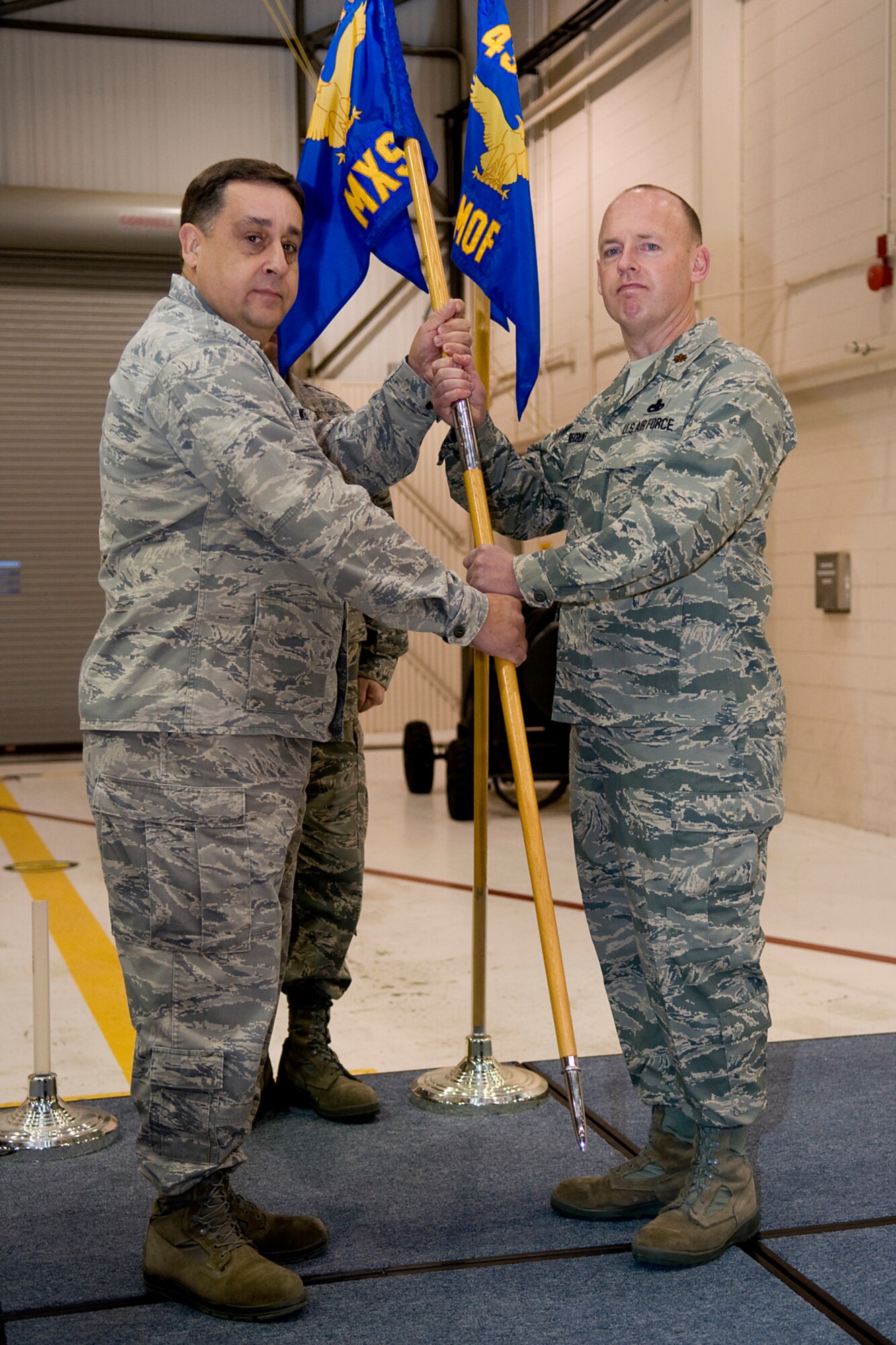GRISSOM AIR RESERVE BASE, Ind. -- Maj. Joel Brecount accepts command of the 434th Aircraft Maintenance Squadron from Col. Paul Weimer during a change of command ceremony here Jan. 7. During the ceremony, Brecount relinquished command of the 434th Maintenance Operations Flight prior to assuming command off the 434th AMXS. Weimer is the 434th Maintenance Group commander. (U.S. Air Force photo/Tech. Sgt. Mark R. W. Orders-Woempner)
