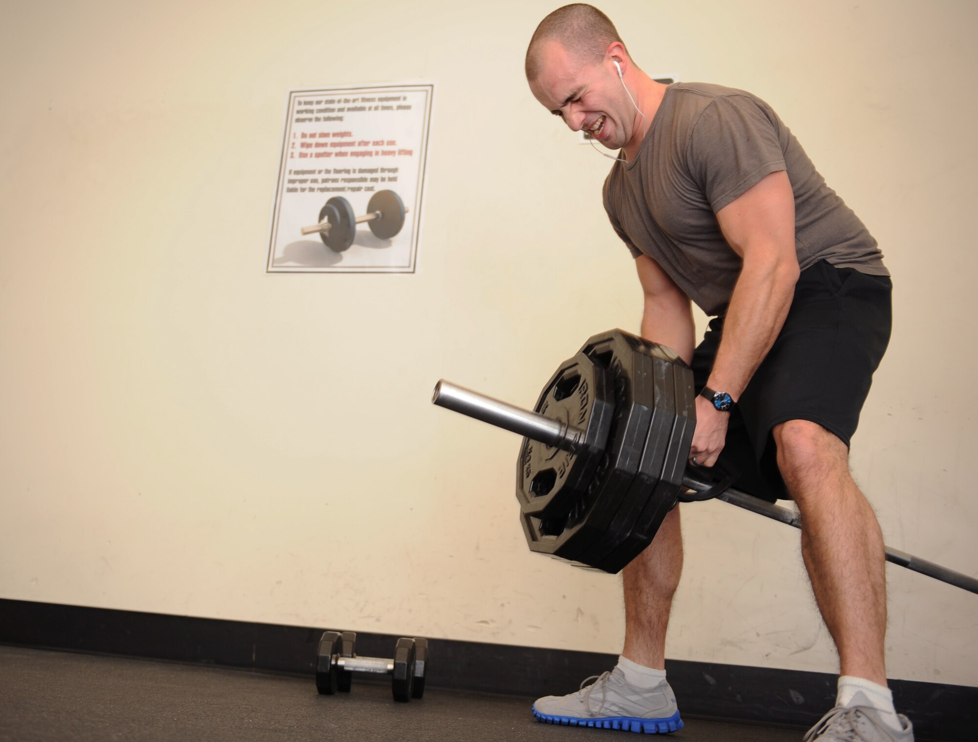 Senior Airman Blaze West, 366th Communications Squadron cyber transport technician, lifts weights during a workout at the fitness center Jan. 6, 2012, at Mountain Home Air Force Base, Idaho. West works out in order to meet Air Force standards for physical training as part of being a combat ready Airman. (U.S. Air Force photo by Airman 1st Class Jonathan Glanville) 