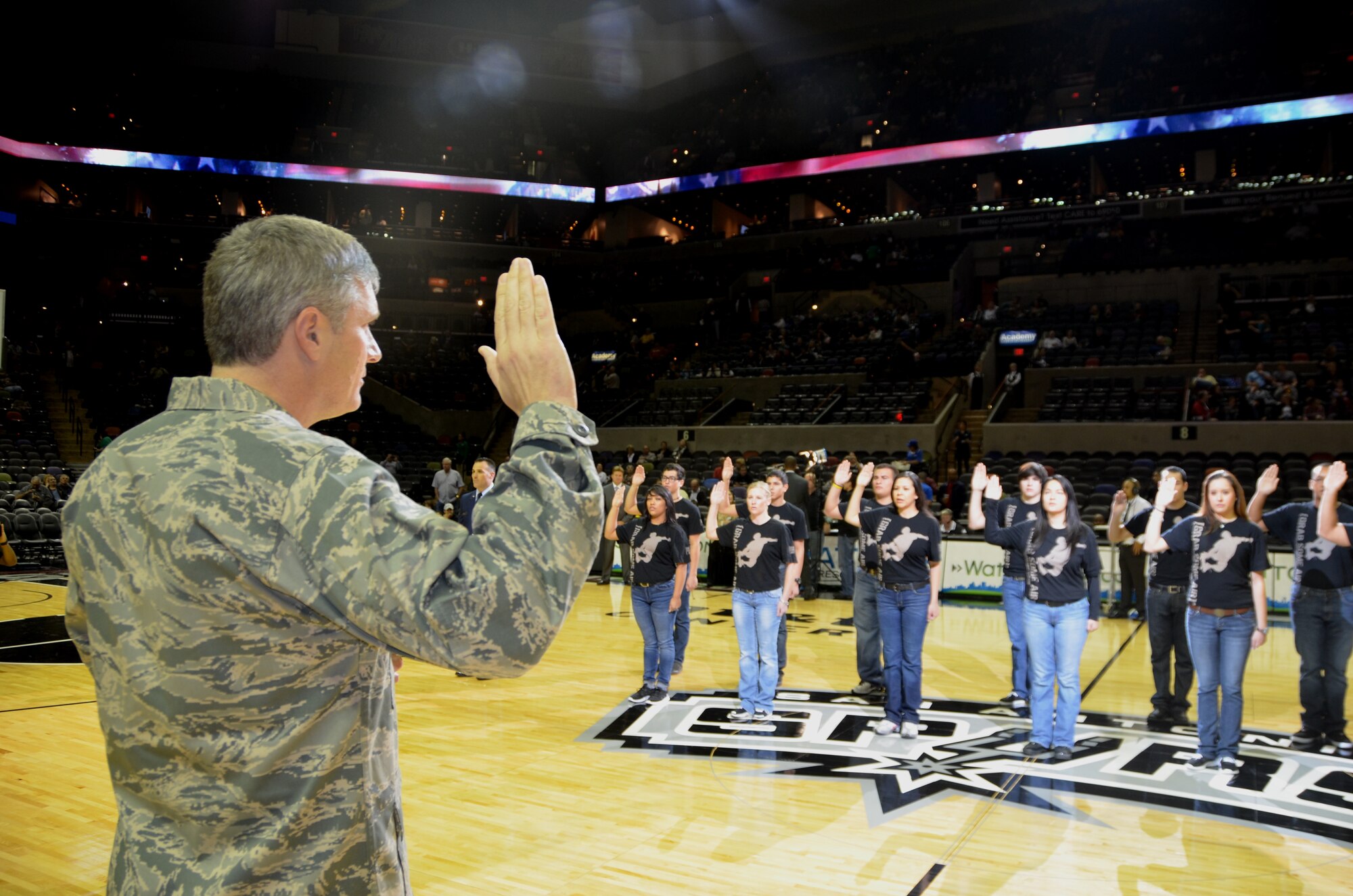 Col. Aaron Vangelisti swears in thirteen new recruits during a mass swearing in ceremony just before a San Antonio Spurs game Jan.5 at the AT&T Center. All thirteen will join the 433rd Airlift Wing in various Air Force specialties. (U.S. Air Force photo by Senior Master Sgt. Minnie Jones)
