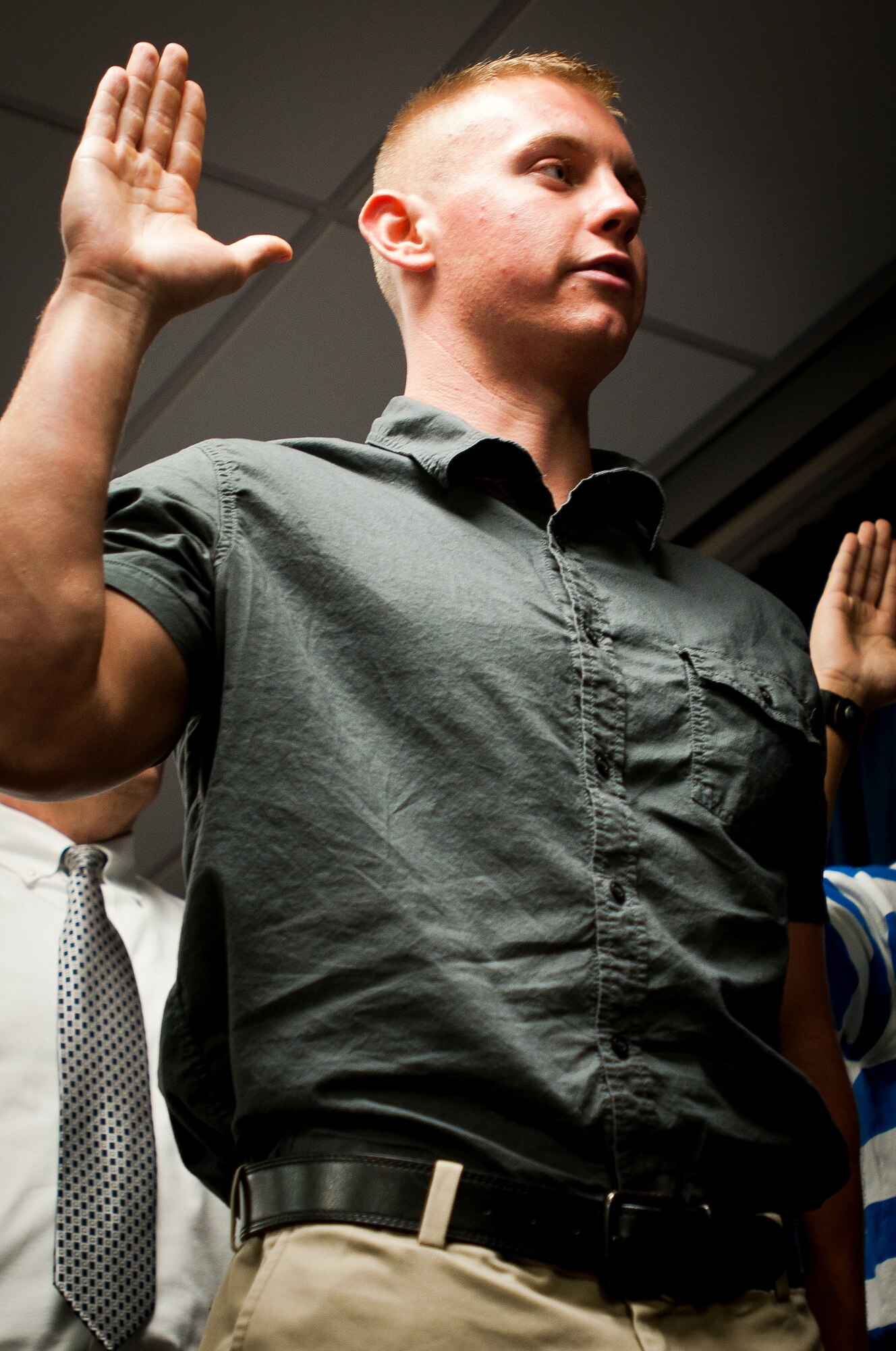 Kaleb Henry takes the Oath of Enlistment during a mass swearing-in ceremony held Sept. 20, 2011, at the Kentucky Air Guard Base in Louisville, Ky. Henry, who most recently worked at a college textbook rental firm, will serve as a C-130 loadmaster in the 123rd Airlift Wing. (U.S. Air Force photo by Master Sgt. Philip Speck)