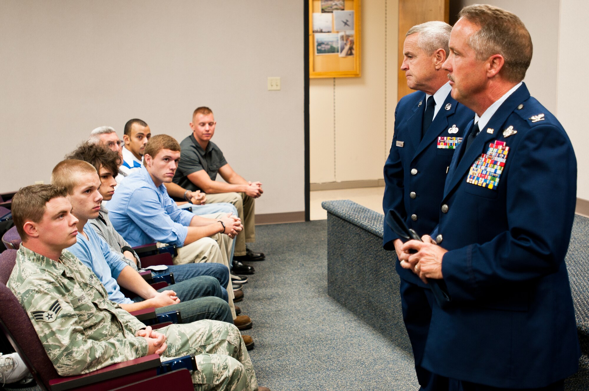 Col. Greg Nelson (right), commander of the Kentucky Air National Guard’s 123rd Airlift Wing, and Chief Master Sgt. Curtis Carpenter (left), wing command chief, greet new recruits during a mass-enlistment ceremony held Sept. 20, 2011, at the Kentucky Air Guard Base in Louisville, Ky. The eight new recruits will be trained for a broad spectrum of responsibilities, from public affairs to aircrew duty. (U.S. Air Force photo by Master Sgt. Philip Speck)