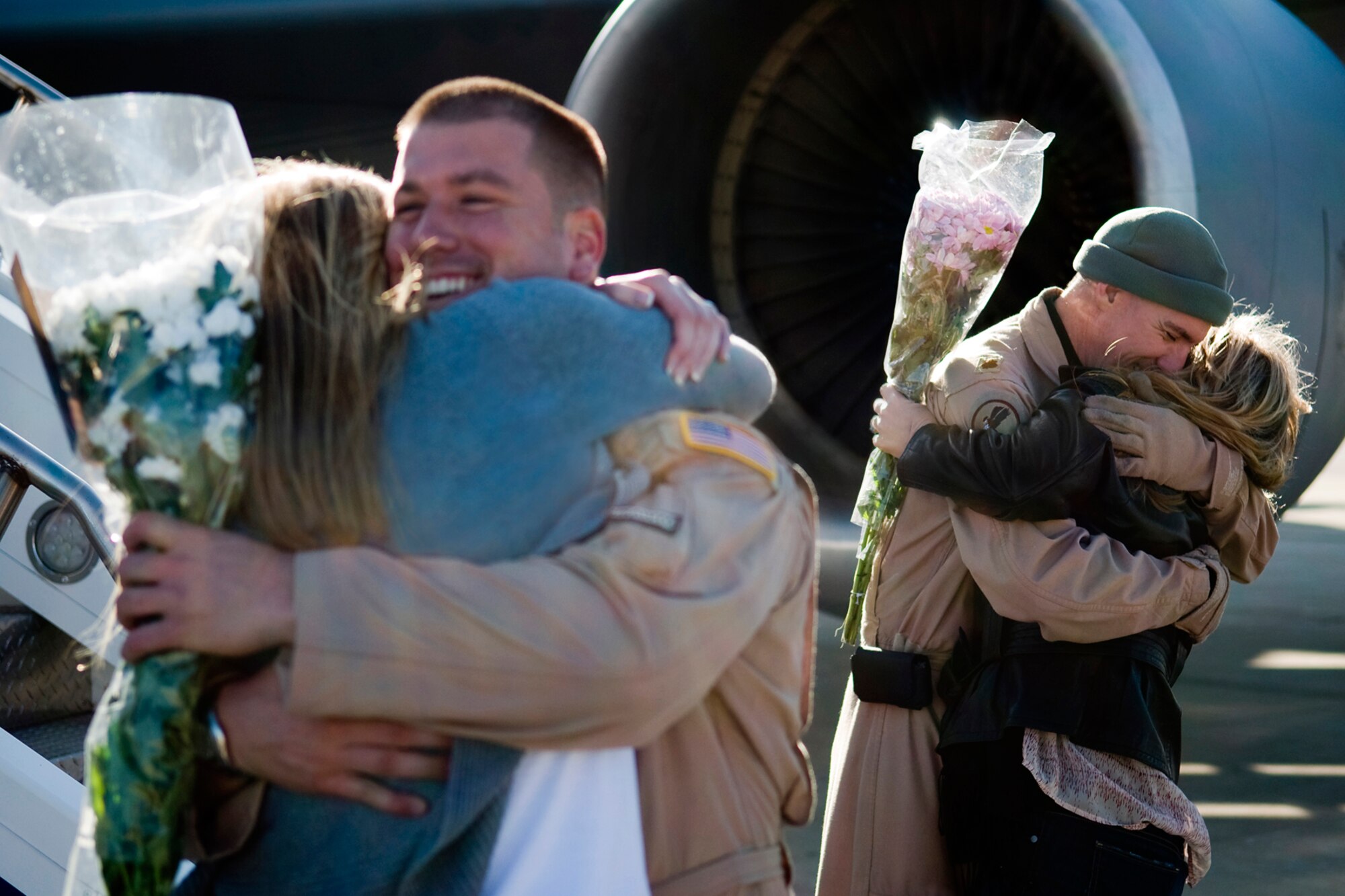 GRISSOM AIR RESERVE BASE, Ind. -- Capt. Jacob Creel, left, and Maj. Billy Werth hug their wives after returning to Grissom from a deployment to Southwest Asia Jan. 5. Stephanie Creel and Haley Werth were both able to welcome back their loved ones after not seeing them for over two months. The two 72nd Air Refueling Wing pilots deployed with several other 434th Air Refueling Wing Airmen for over two months in support of Operations Enduing Freedom and Odyssey Dawn. (U.S. Air Force photo/Tech. Sgt. Mark R. W. Orders-Woempner)
