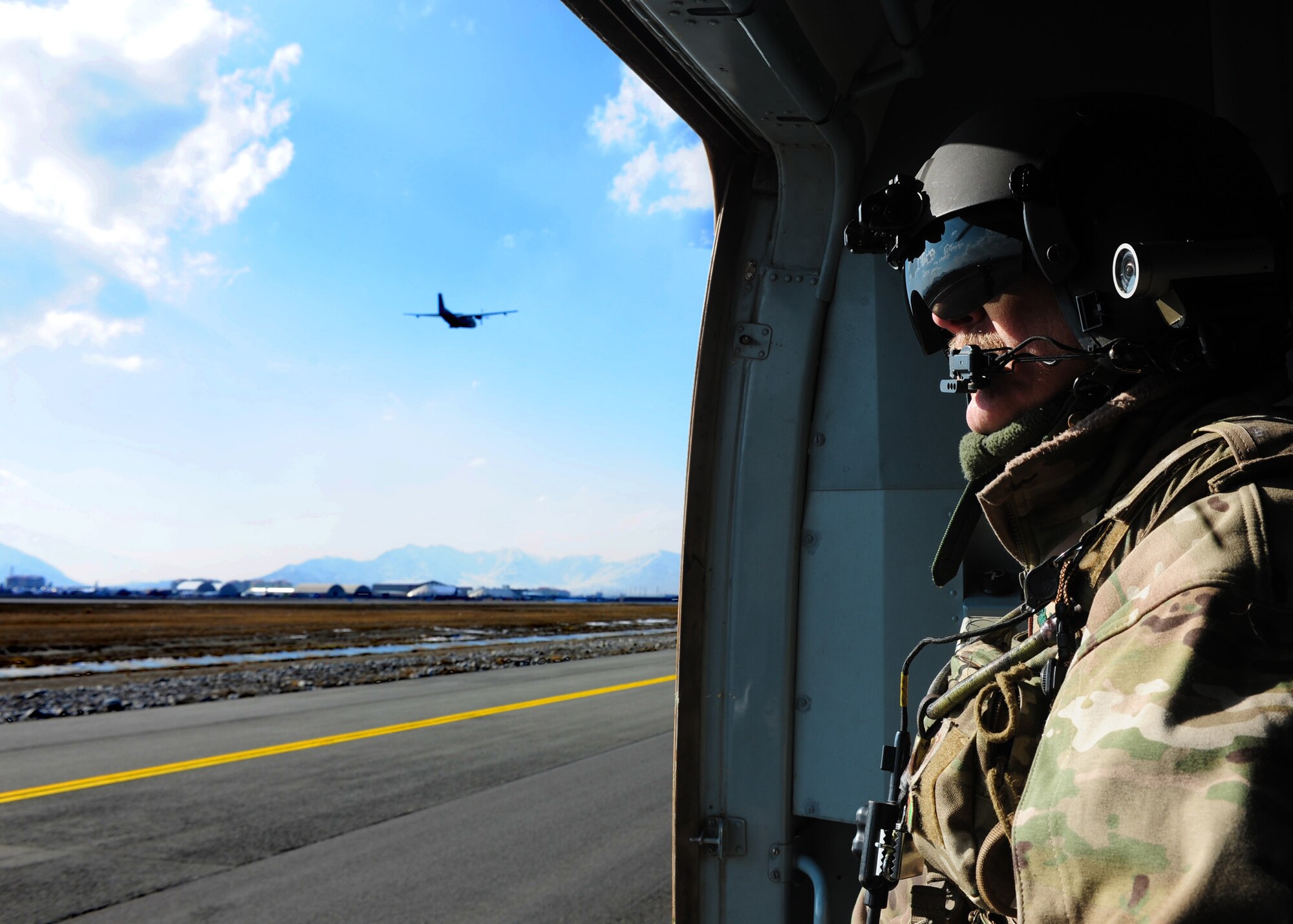 Senior Master Sgt. Todd Peplow, an aerial gunner with the 438th Air Expeditionary Advisory Squadron, overlooks the Kabul International Airport flightline after completing a flight between Jalalabad and Kabul, Afghanistan, Jan. 5, 2012. Peplow is currently deployed to provide advisory training for Afghan air force flight engineers. (U.S. Air Force photo by Staff Sgt. Nadine Y. Barclay)
