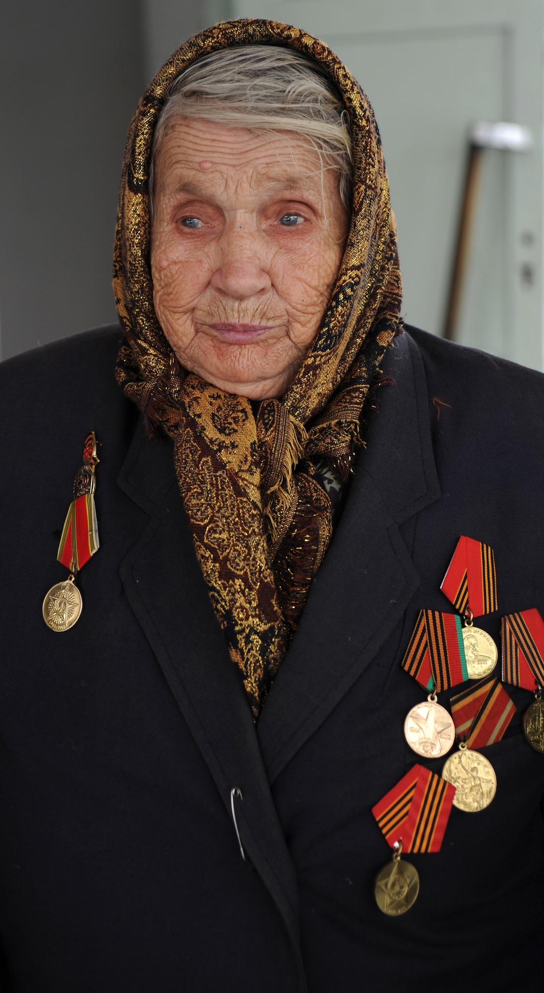 Introducing herself as Mama Valentina, Valentina Kiselyova, a decorated WWII veteran who served in the Soviet Army as a spy from 1941 to 1946, participates in an Operation Warm and Dry coat distribution at the Vinogradnoye Village administration building, Jan. 5, 2012, Kyrgyzstan. Now 90-years-old, Kiselyova was born in Siberia and moved to Kyrgyzstan after WWII. She arrived at the administration building proudly wearing six gold Army medals on a worn-black blazer which was held closed by a safety pin. "Thank you," said Kiselyova after receiving her new coat. 
 (U.S. Air Force photo/Master Sgt. Tracy L. DeMarco)
