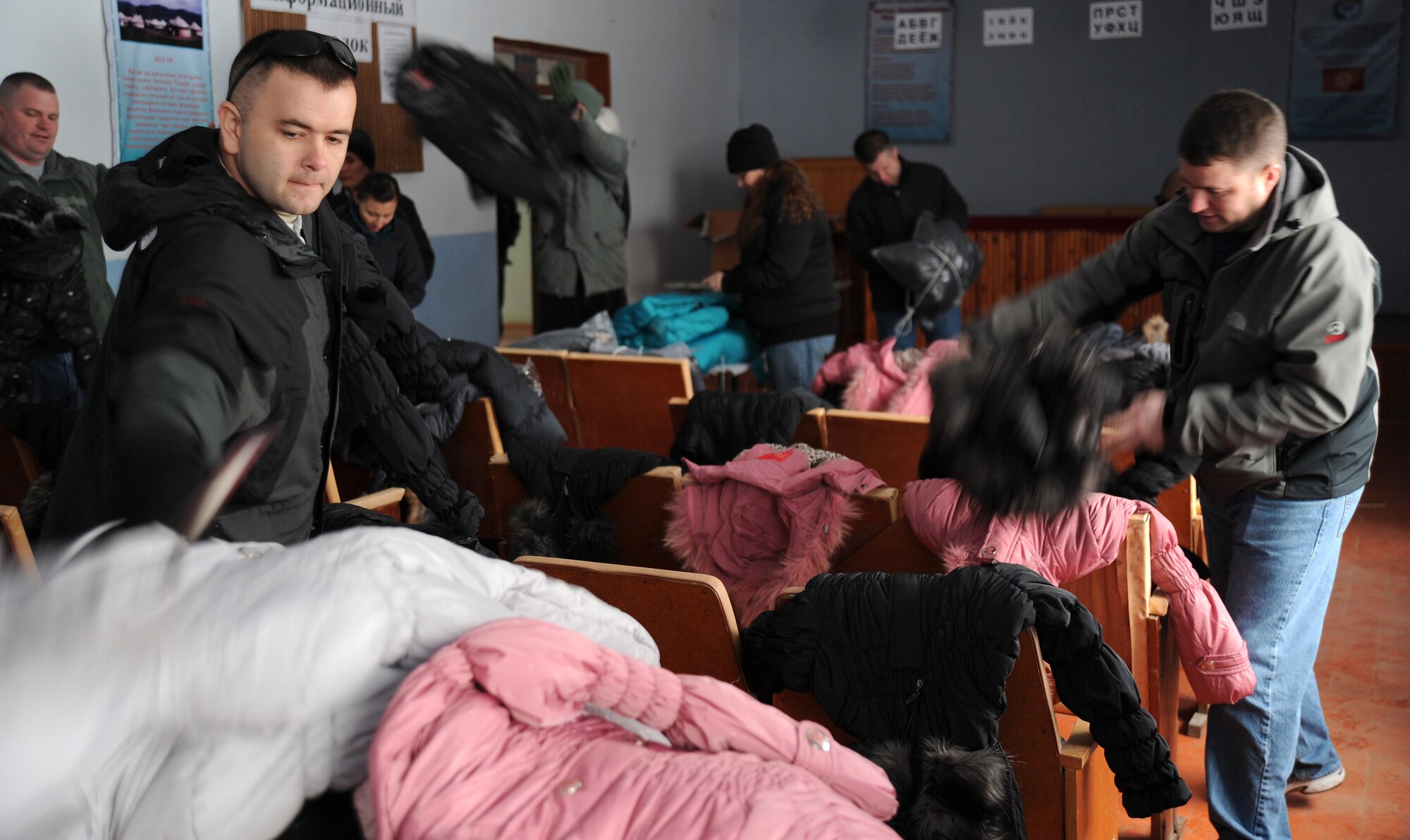 Tech. Sgt. Justin Dixon, a chief boom operator and acting first sergeant with the 22nd Expeditionary Air Refueling Squadron, along with seven more volunteers from the Transit Center at Manas, sort new coats by gender and size in preparation for an Operation Warm and Dry distribution event held at the Vinogradnoye Village administration building, Jan. 5, 2012, Kyrgyzstan. This is the first time that Dixon had participated in a Warm and Dry distribution and when asked why he attended, he said that he knows the Kyrgyz people need help. Dixon is deployed here from Fairchild Air Force Base, Wash. 
(U.S. Air Force photo/Master Sgt. Tracy L. DeMarco)
