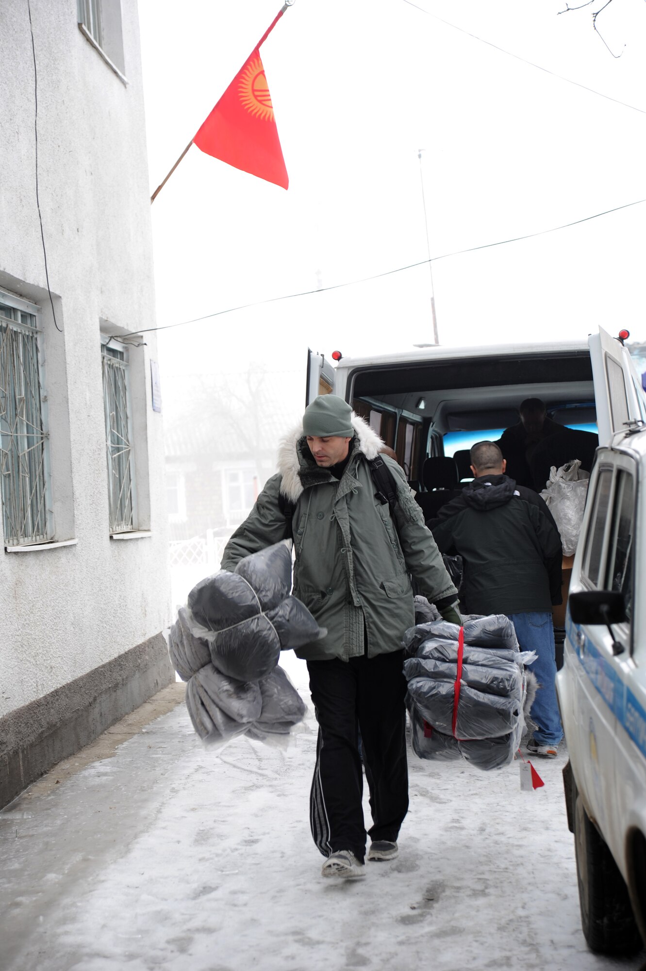 Senior Master Sgt. James Fitch, the superintendent of the 376th Expeditionary Operations Group at the Transit Center at Manas, Kyrgyzstan, unloads new coats into the Vinogradnoye Village administration building during set-up for an Operation Warm and Dry distribution event held Jan. 5, 2012. "It was very tiring but very rewarding, the people were very happy," Fitch said. More than 50 coats were given away in Vinogradnoye. Fitch is deployed here from Fairchild Air Force Base, Wash.
(U.S. Air Force photo/Master Sgt. Tracy L. DeMarco)
