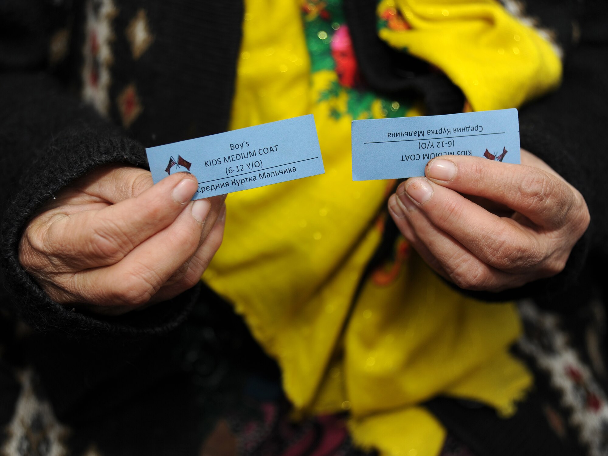 Displaying her two blue tickets, Maili waits in line at the Operation Warm and Dry distribution event held at the Vasilievka Elementary School, Jan. 5, 2012, Kyrygyzstan. Approximately 160 people from Vasilievka Village received new coats including Maili's two sons, Zukhuriddin, age 14, and Faridun, age 10. Operation Warm and Dry is a program sponsored and managed by the Theater Security Cooperation division at the Transit Center at Manas.
(U.S. Air Force photo/Master Sgt. Tracy L. DeMarco)
