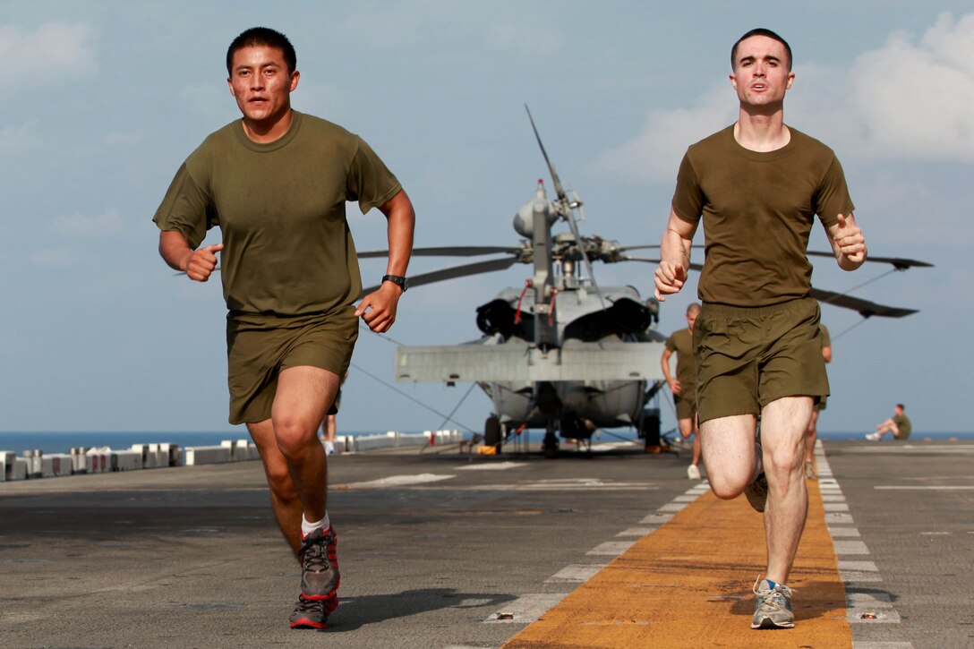 Cpl. Natashkie J. Yazzie, left, and Lance Cpl. Michael D. Rodgers run aboard USS Makin Island (LHD 8) here Jan. 7. Yazzie and Rodgers serve with the 11th Marine Expeditionary Unit's Combat Logistics Battalion 11. The battalion provides logistics and services for the 11th Marine Expeditionary Unit. The 11th MEU is currently deployed as part of the Makin Island Amphibious Ready Group (MKIARG) as the U.S. Central Command theater reserve force, also providing support for maritime security operations and theater security cooperation efforts in the U.S. 5th Fleet area of responsibility. Yazzie, 22, hails from Chinle, Ariz. Rodgers, 21, hails from Chicago.