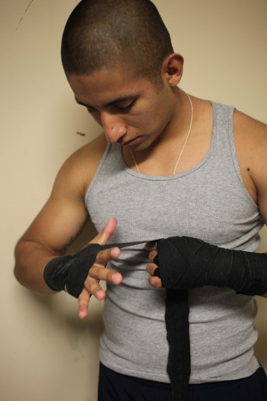 Cpl. Alfonzo Ruiz, a field wireman with 2nd Combat Engineer Battalion, 2nd Marine Division, wraps his hands before practicing his boxing skills at a gym aboard Marine Corps Base, Camp Lejeune, N.C., Jan. 8. 2012. Ruiz is currently training five to six days a week to prepare for a tryout for the Marine Corps boxing team.