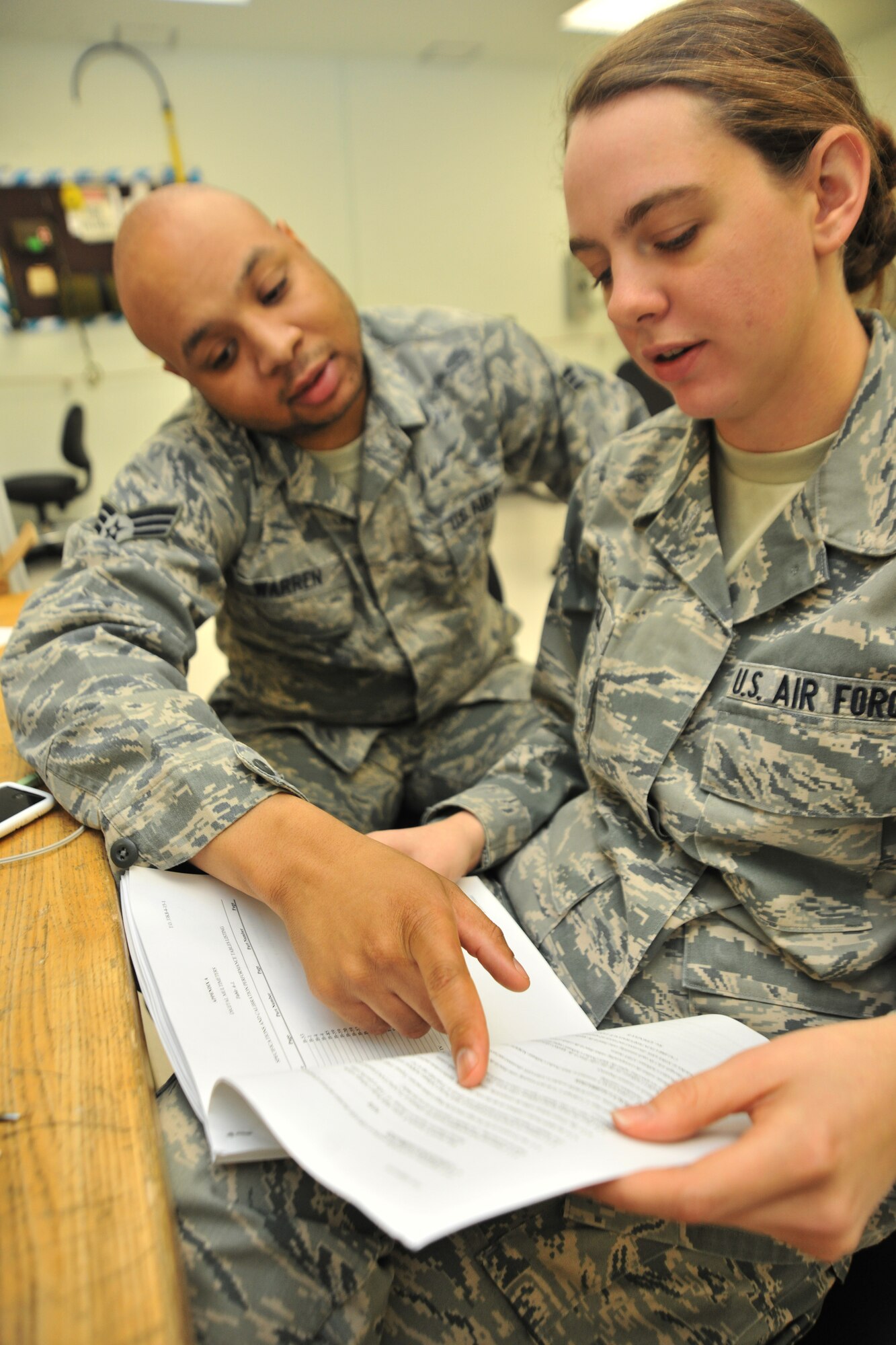 Senior Airman Kenny Warren, 8th Maintenance Squadron precision and measurement equipment laboratory journeyman, helps Airman 1st Class Kayleigh McGill, 8th MXS PMEL apprentice, with her upgrade training at Kunsan Air Base, Republic of Korea, Jan. 5, 2012. Precision and measurement equipment laboratory specialists are responsible for calibrating equipment used in virtually every phase of maintenance for nearly every piece of equipment the Air Force operates. (U.S. Air Force photo by Senior Airman Brittany Y. Auld/Released)