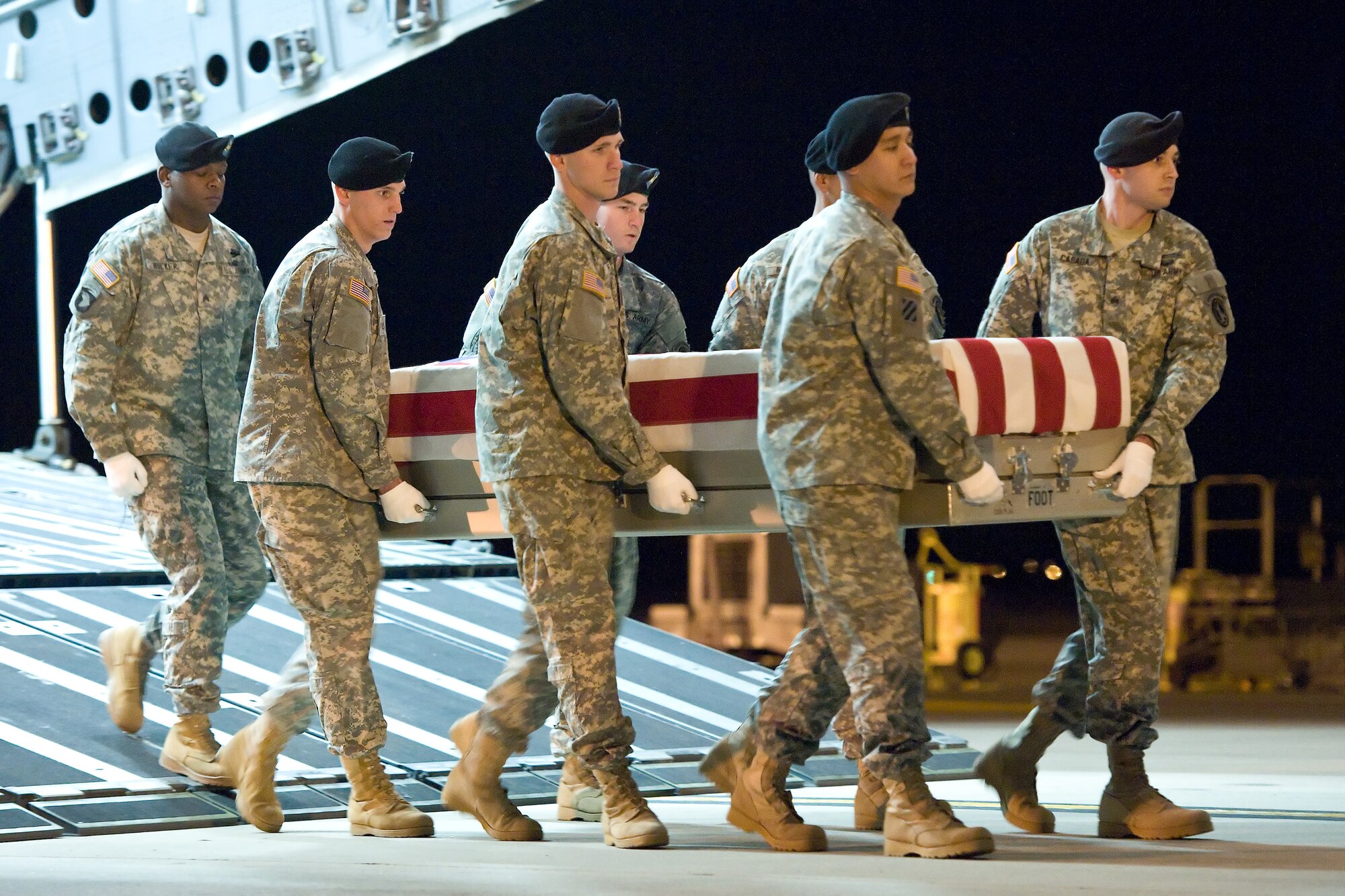 A U.S. Army carry team transfers the remains of Army Spc. Christopher A. Patterson, of North Aurora, Ill., at Dover Air Force Base, Del., Jan. 8, 2012. Patterson was assigned to the 713th Engineer Company, Indiana National Guard, Valparaiso, Ind. (U.S. Air Force photo/Roland Balik)