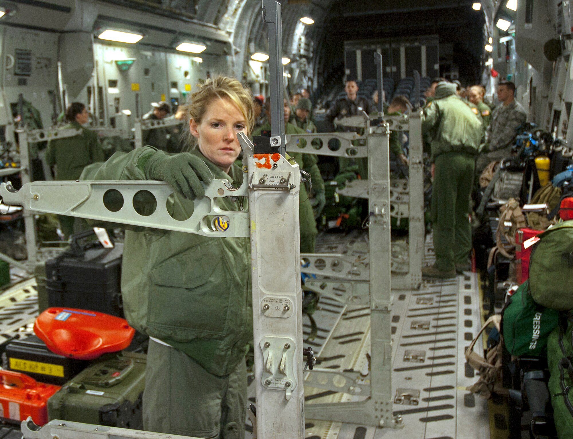 Tech. Sgt. Suzanne Redo, 446th Aeromedical Evacuation Squadron, helps configure a C-17 Globemaster III to carry 36 litters during a squadron exercise.  More than 30 446th AES members participated in the flight departing from McChord Field Jan. 8, 2012.  The exercise included scenarios where patients injured in combat needed to be loaded and cared for on a four-hour flight around the local area.  These training exercises occur monthly and enable Reservists to hone their skills for real-world deployments and humanitarian missions.