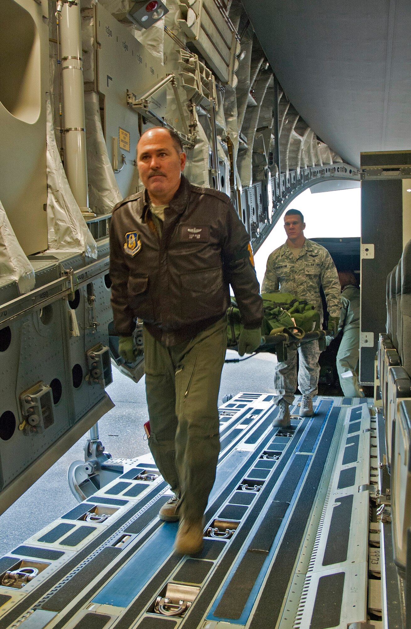 Master Sgt. David Allan and Senior Airman Brad Kranendonk, 446th Aeromedical Evacuation Squadron help load litters and configure a C-17 Globemaster III to carry 36 litters during a squadron exercise.  More than 30 446th AES members participated in the flight departing from McChord Field Jan. 8, 2012.  The exercise included scenarios where patients injured in combat needed to be loaded and cared for on a four-hour flight around the local area.  These training exercises occur monthly and enable Reservists to hone their skills for real-world deployments and humanitarian missions.