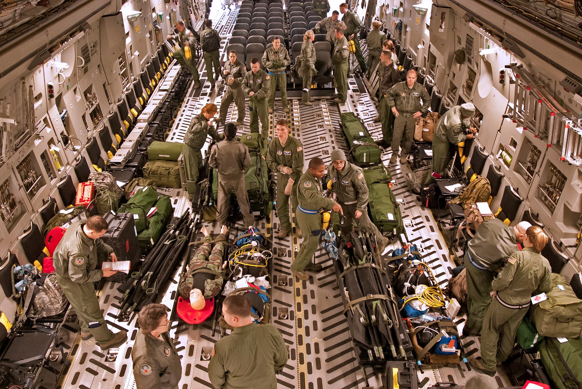 More than 30 members from the 446th Aeromedical Evacuation Squadron help configure a C-17 Globemaster III.  The Reservists participated in the flight departing from McChord Field Jan. 8, 2012.  The exercise included scenarios where patients injured in combat needed to be loaded and cared for on a four-hour flight around the local area.  These training exercises occur monthly and enable Reservists to hone their skills for real-world deployments and humanitarian missions.