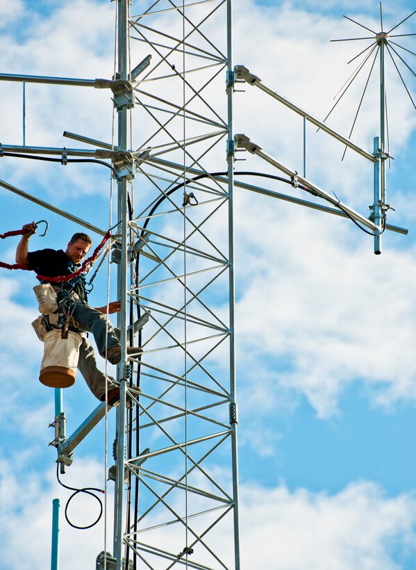 James Wolf, of LTI data communications, moves down from the top of the communications tower beside the 919th Special Operations Wing headquarters building at Duke Field.  Reservists will move in to the newly-renovated headquarters during the January unit training assembly.  (U.S. Air Force/Tech. Sgt. Samuel King Jr.)