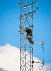 James Wolf, of LTI data communications, checks below as he climbs to the top of the communications tower beside the 919th Special Operations Wing headquarters building at Duke Field.  Reservists will move in to the newly-renovated headquarters during the January unit training assembly.  (U.S. Air Force/Tech. Sgt. Samuel King Jr.)