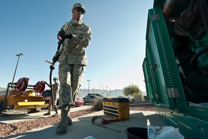 U.S. Air Force Senior Airman Johnathon Copeland, 99th Civil Engineer Squadron electrical power production apprentice, conducts scheduled maintenance on an Emergency Standby Generator during an annual inspection at Fire Station 3 Jan. 6, 2012, at Nellis Air Force Base, Nev. 99th CES power production Airmen, provide maintenance for over 60 generators on Nellis AFB. (U.S. Air Force photo by Staff Sgt. Christopher Hubenthal/Released)