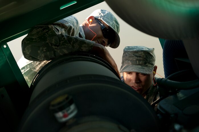 U.S. Air Force Senior Airman Johnathon Copeland, 99th Civil Engineer Squadron electrical power production apprentice and Staff Sgt. Peter Salmeri, 99th Civil Engineer Squadron electrical power production craftsman, change a filter in an Emergency Standby Generator during an annual inspection at Fire Station 3 Jan. 6, 2012, at Nellis Air Force Base, Nev. 99th CES power production Airmen, provide maintenance for over 60 generators on Nellis AFB. (U.S. Air Force photo by Staff Sgt. Christopher Hubenthal/Released)
