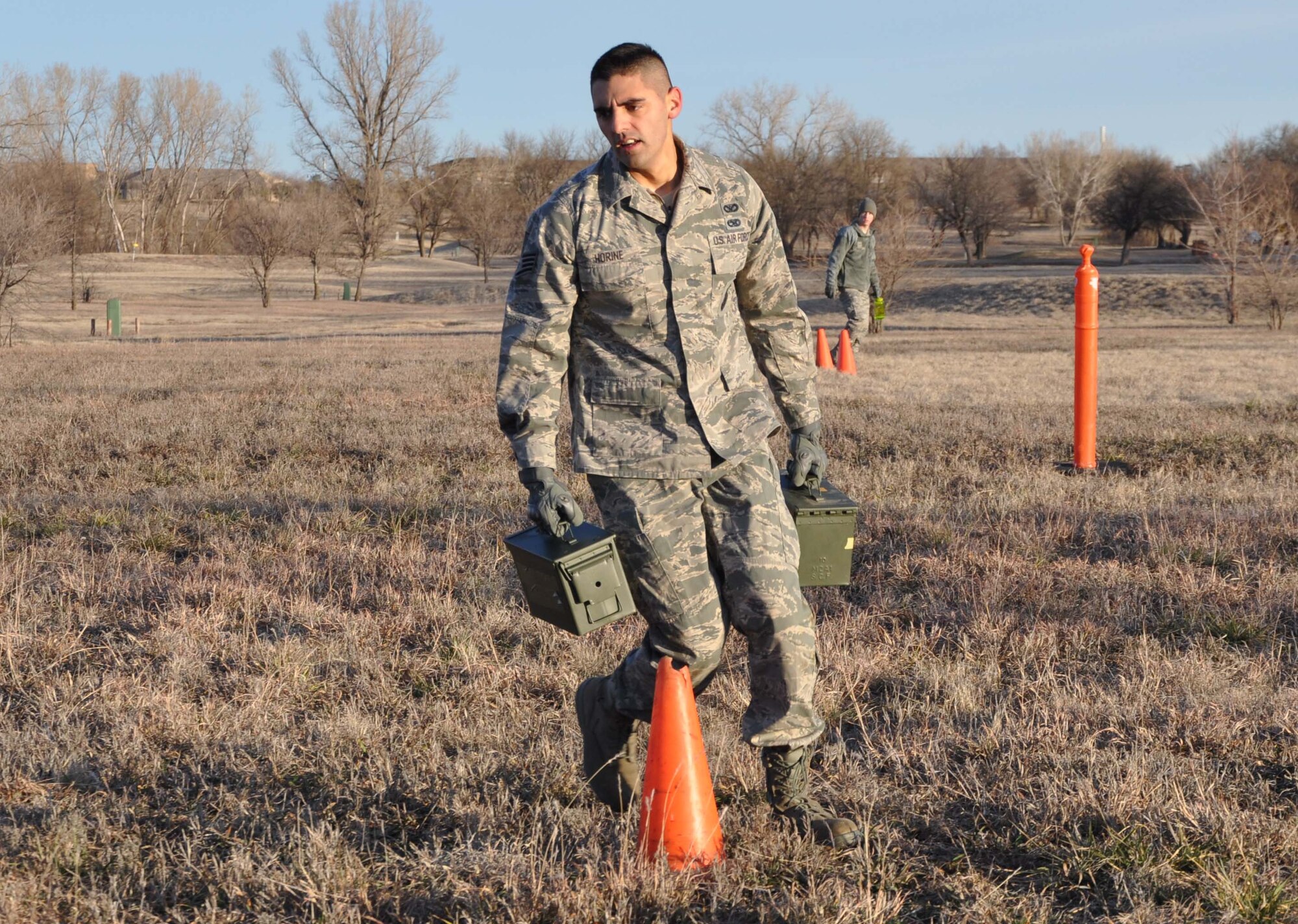 Staff Sgt. Nick Horine, 931st Security Forces Squadron, sprints while carrying ammo cans as part of a combat fitness course conducted by the squadron, Jan. 7, 2012.  The course was part of a two-day combat training regimen the squadron performed over the January unit training assembly, which included martial arts and ground fighting skills training as well.  (U.S. Air Force photo by 1st Lt. Zach Anderson)