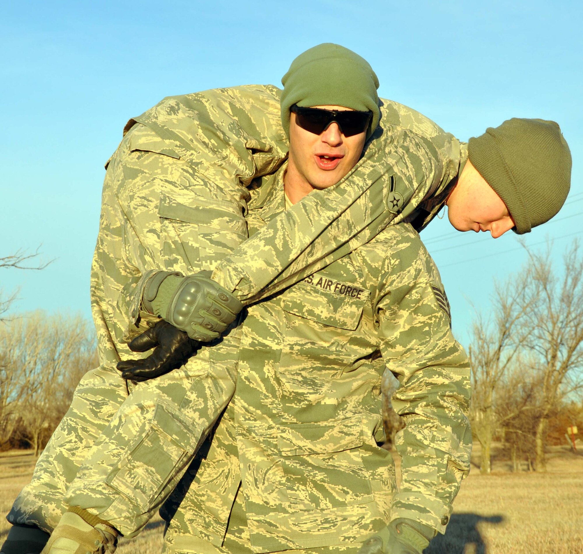 Staff Sgt. Dustin Wileman, 931st Security Forces Squadron, displays the proper technique for conducting a fireman's carry, Jan. 7, 2012.  The 931st SFS spent the morning running through a combat fitness test, which incorporated movements that would be required in battlefield scenarios, such as the fireman's carry to evacuate casualties.  (U.S. Air Force photo by 1st Lt. Zach Anderson)