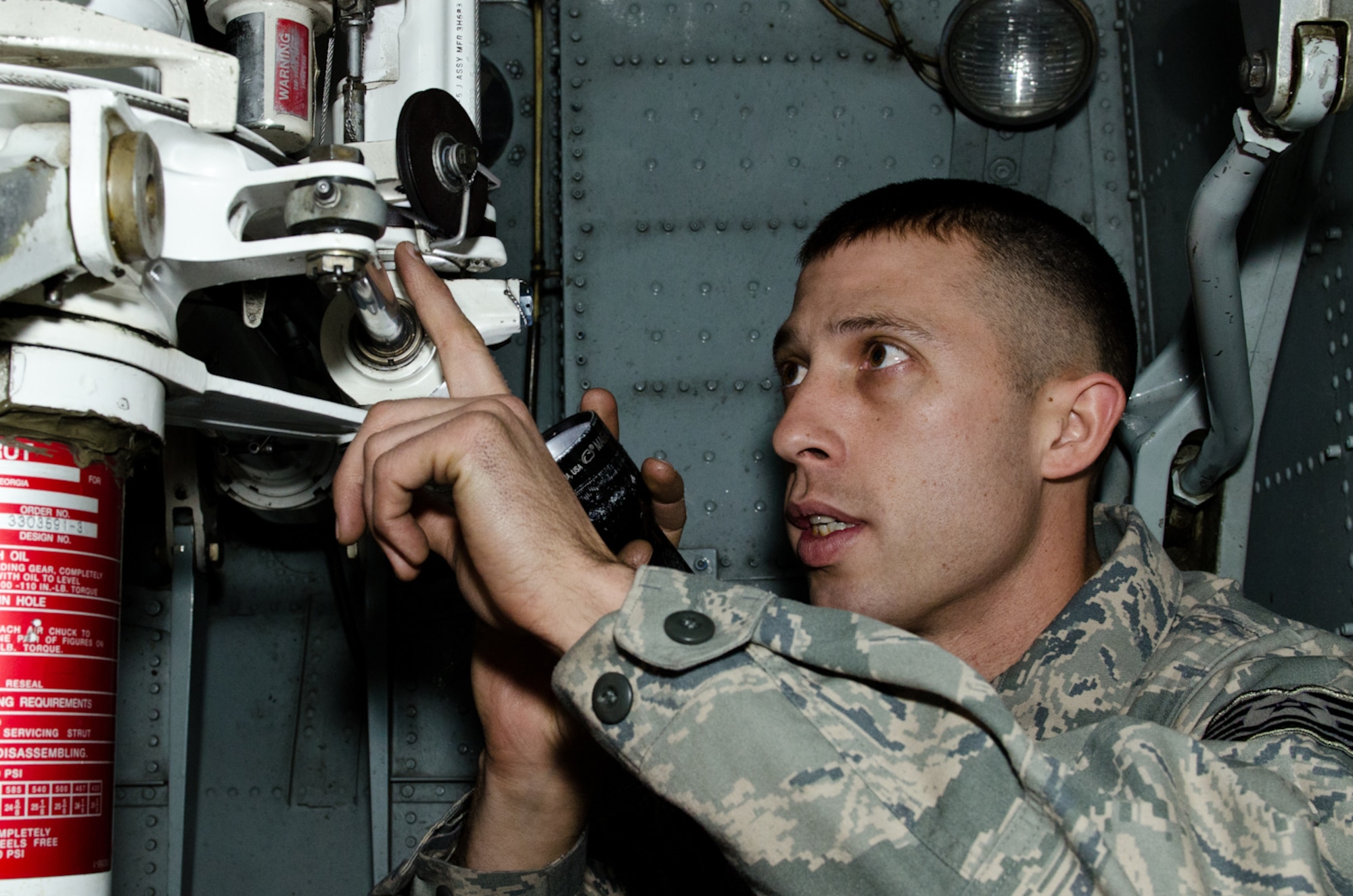 Tech. Sgt. Fred Pierce, 139th Aircraft Maintenance Squadron crew chief, points to the nose landing gear steering control valve of a C-130 Hercules aircraft at Rosecrans Air National Guard Base, St. Joseph, Mo., on Dec. 29, 2011. Pierce was selected as the Outstanding Noncommissioned Officer of the Year for the Missouri Air National Guard. (Missouri Air National Guard photo by Staff Sgt. Michael Crane)