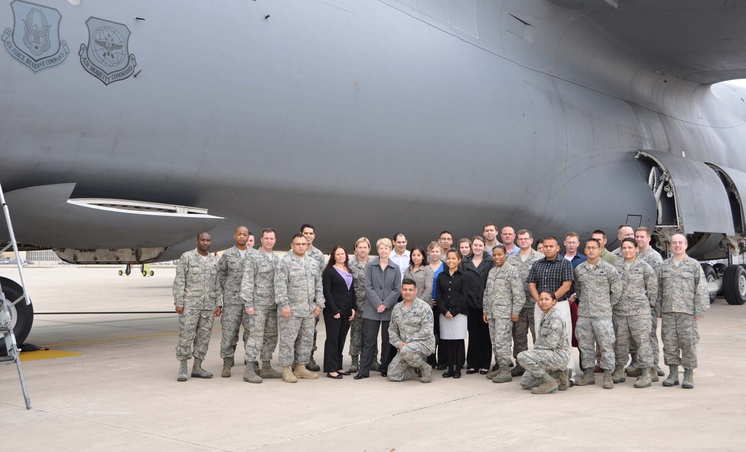 New Airmen to the 433rd Airlift Wing gather in front of a C-5A Galaxy cargo aircraft during a tour introducing them to Lackland Air Force Base, Texas, Jan 7. The tour served as a way to help get incoming Airmen acclimated to the sites of Lackland and assisted with questions about the wing. (U.S. Air Force photo/ Senior Airman Viola M. Hernandez) 