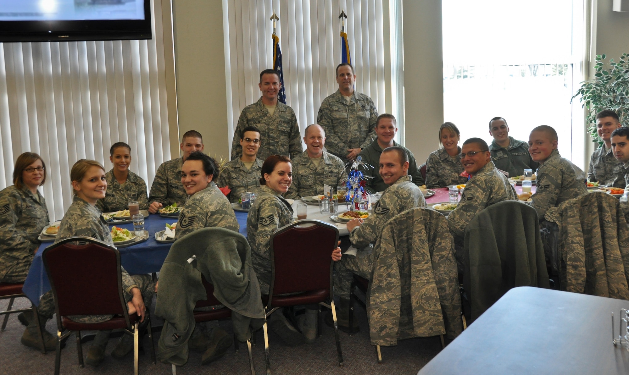Command Chief Master Sgt. Christopher E. Muncy, command chief of the Air National Guard, prepares to eat lunch and converse with 15 members of the 128th Air Refueling Wing's enlisted Airmen in Milwaukee on January 08, 2012. Muncy was at the 128 ARW as part of a tour of all the Air National Guard bases located in Wisconsin. USAF Photograph by Staff Sgt. Jeremy Wilson