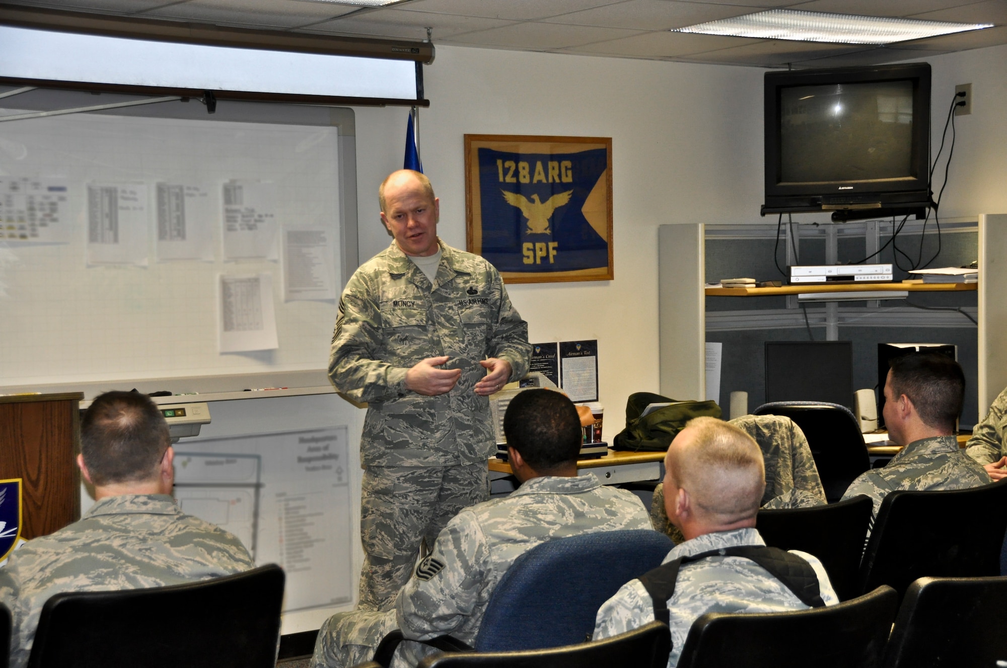 Command Chief Master Sgt. Christopher E. Muncy, command chief of the Air National Guard, addresses members of the 128th Air Refueling Wing's security forces in Milwaukee on January 08, 2012. Muncy was at the 128 ARW as part of a tour of all the Air National Guard bases located in Wisconsin. USAF Photograph by Staff Sgt. Jeremy Wilson