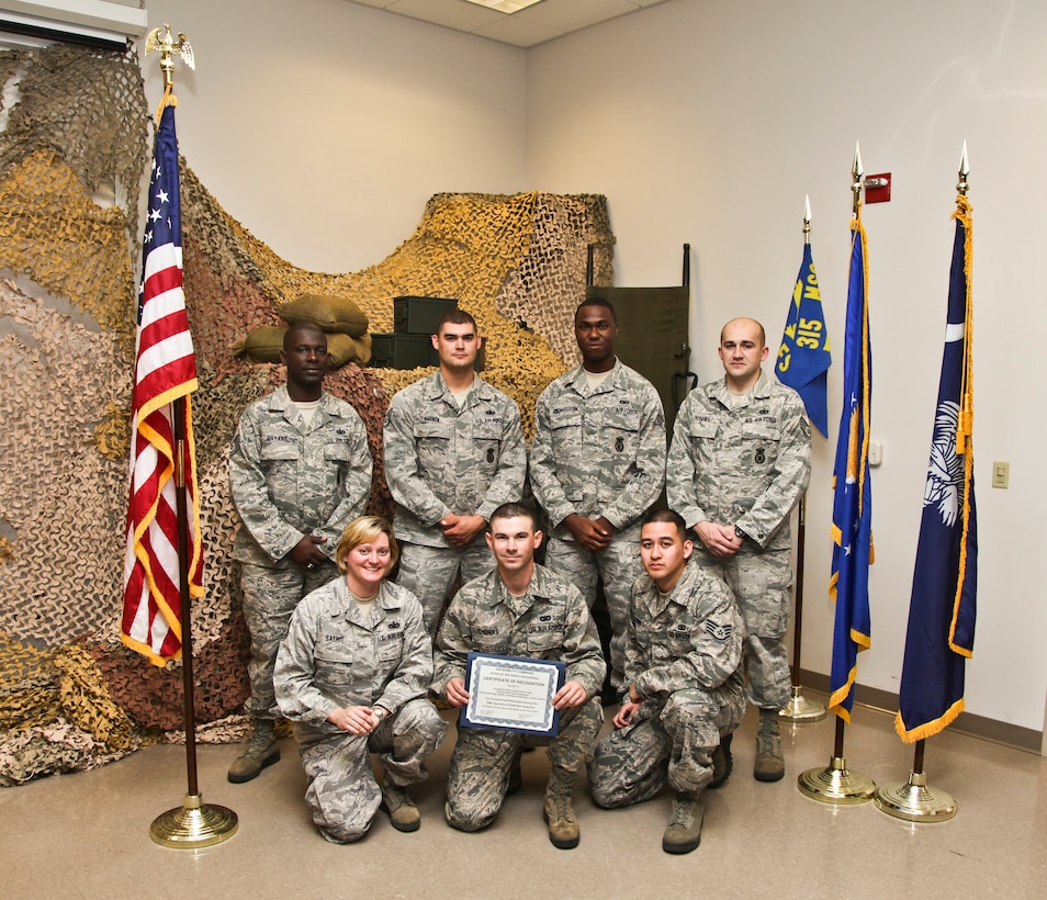 Members of the 315th Airlift Wing Security Forces Squadron who recently particpated in the 2011 Air Mobility Command Operational Readiness Inspection November 30 through December 6, display their certificate of "Outstanding Performance" during the excercise.  Pictured from left to right: (top row) Tech. Sgt. James Bryant, Staff Sgt. Brandon D. Harmon, Senior Airman Desimone A. Richardson and Staff Sgt. David Rogers (bottom row) Tech. Sgt. Lisa B. Safrit, Staff Sgt. David M. Thomas and Staff Sgt. Ryan Neil O. Quini. 