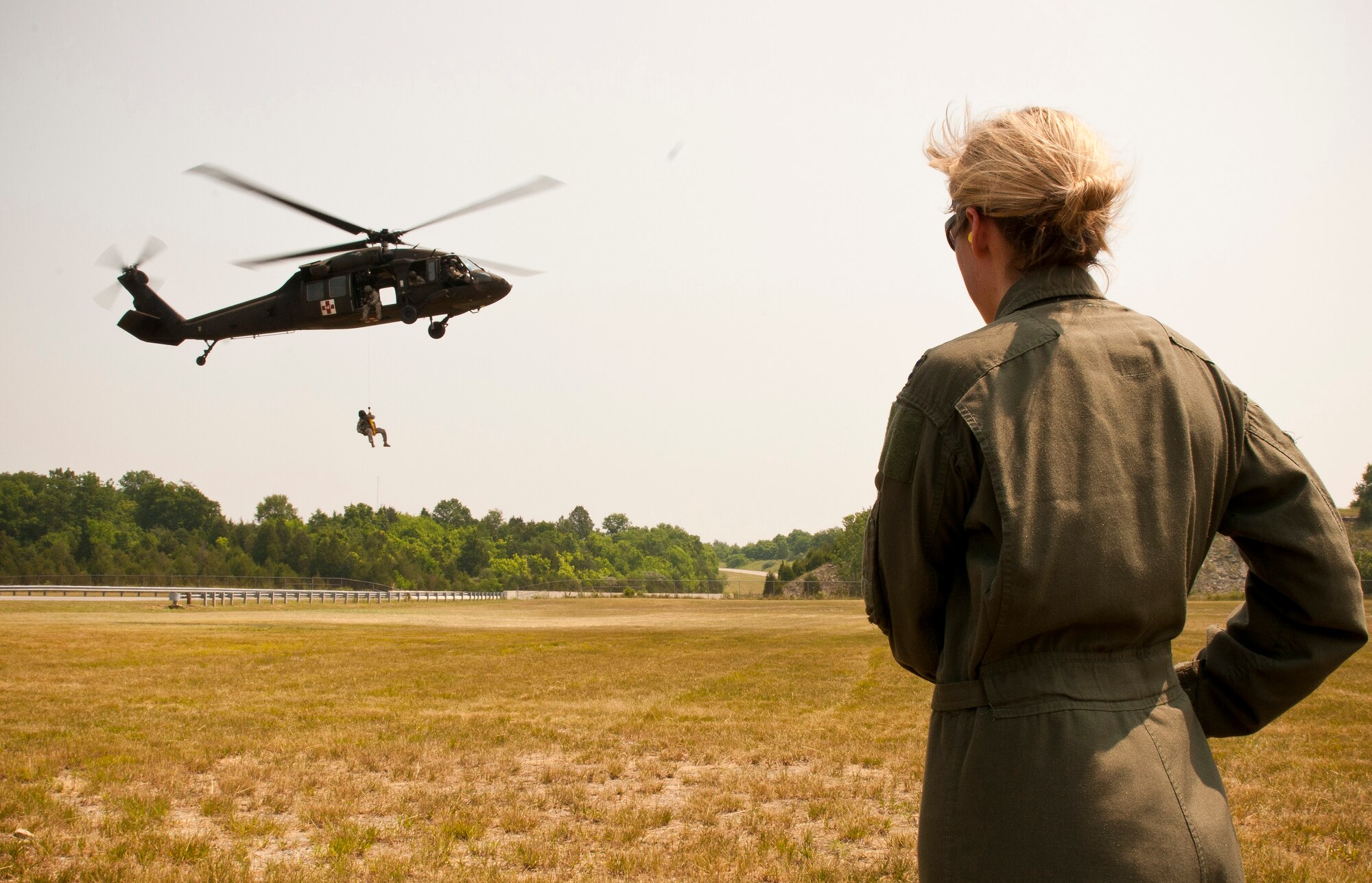 Capt. Jennifer Nash, a Hercules C-130 pilot for the Kentucky Air National Guard's 165th Airlift Squadron, waits to be extracted by a Kentucky Army National Guard UH-60 Blackhawk during survival training held June 9, 2011, in Taylorsville, Ky. The UH-60 crew of four soldiers is assigned to Detachment 1, Charlie Company, 238th Aviation Brigade in Frankfort, Ky. (U.S. Air Force photo by Senior Airman Maxwell Rechel)