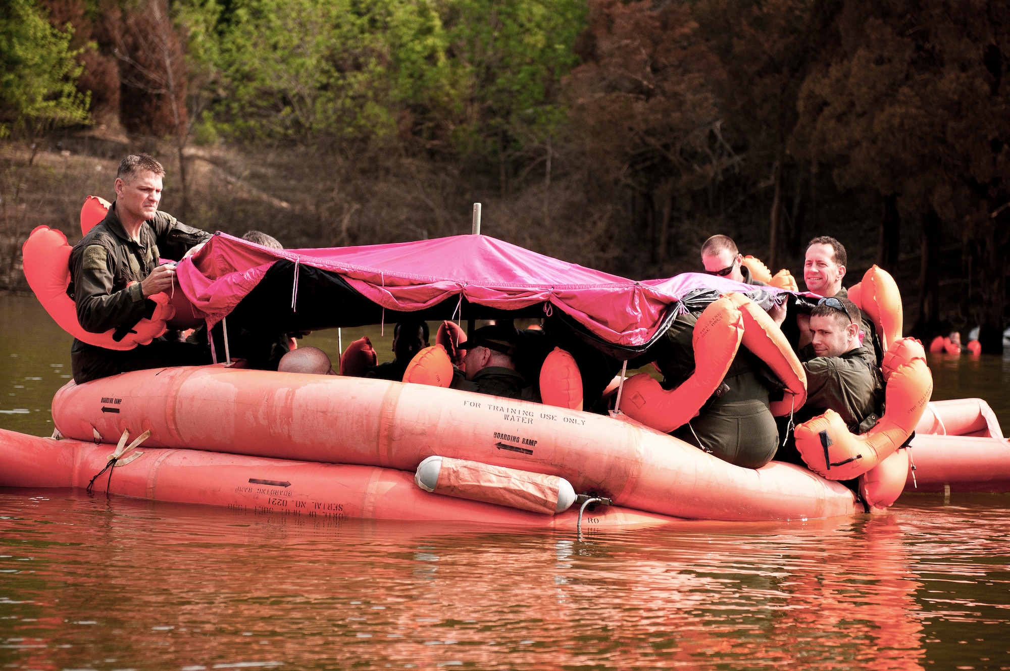 Col. Barry Gorter (far left), commander of the 123rd Operations Group, sets up a life raft with other Airmen from the Kentucky Air National Guard during survival training at Taylorsville Lake in Taylorsville, Ky., on June 9, 2011. The training is required of aircrew members every three years. (U.S. Air Force photo by Senior Airman Maxwell Rechel)