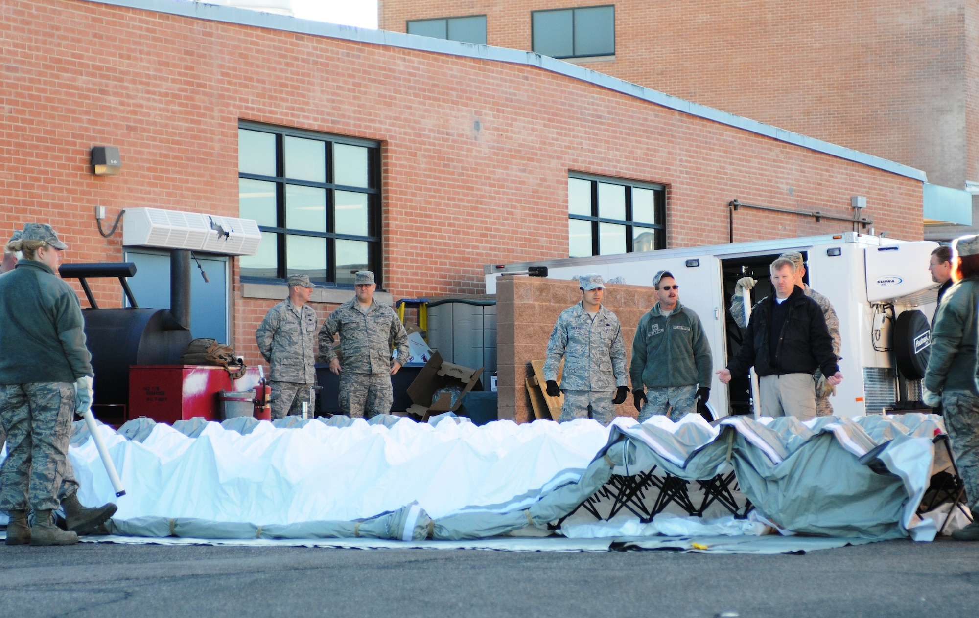 Members of the 11-man fatality search and recovery team learn to assemble the quick-erect shelter system. (U.S. Air Force photo/1st Lt. Angela Walz)