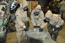 Reservists fom the 446th Airlift Wing train for contingency operations Jan. 8 at McChord Field, Wash.  Their mission readiness training included donning protective gear for mission-oriented protective postures and practicing decontamination procedures.  (U.S. Air Force photo by Tech. Sgt. Elizabeth Moody)